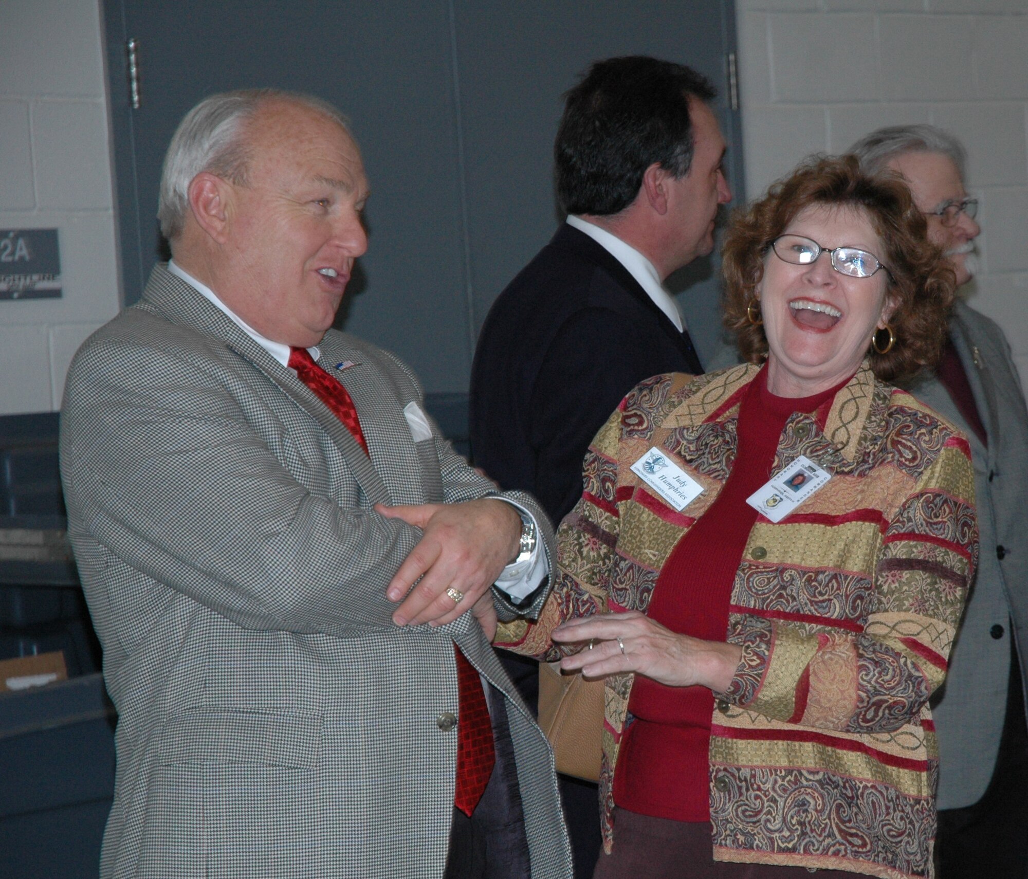 Don Beaver, chief operating officer and senior vice president of business development at the Cobb Chamber of Commerce, shares a laugh with Judy Humphries, executive secretary to the county manager, during The Honorary Commanders Association reception that celebrated a new year and commemorated their 25th year with a reception here that included nearly 100 members from past classes, as well as those who are current class members. The Honorary Commanders Association is spearheaded by the Cobb County Chamber of Commerce and the 94th Airlift Wing, but is a joint effort with the other military services on Dobbins, Lockheed-Martin and NAS Atlanta.(U.S. Air Force Photo/Micah Garbarino)