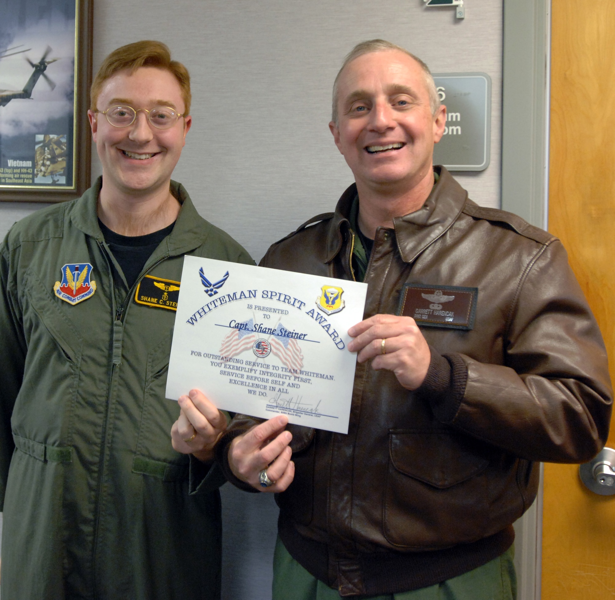 Capt. Chane Steiner receives the Whiteman Spirit Award from Brig. Gen. Garrett Harencak