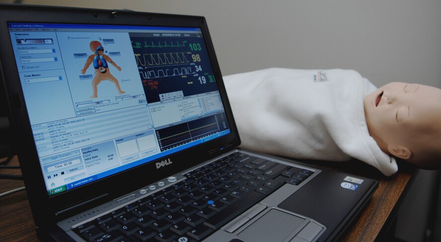 MOODY AIR FORCE BASE, Ga. – An evaluator uses the patient simulation computer to control the Advance Life Support simulator baby’s vital here March 26.  This is used to test the response abilities of nurses, doctors and emergengy medical technicians on different scenarios that could happen in real-world situations. (U.S. Air Force photo by Senior Airman Angelita Lawrence)