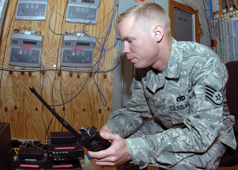 DYESS AIR FORCE BASE, Texas -- Staff Sergeant Nicholas Siburt waits for a response over the radio from the base fire station, March 25. Sergeant Siburt was performing routine maintenance on the command post's radio network. (U.S. Air Force Photo by Airman 1st Class Micheal Breaux)