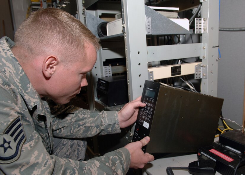 DYESS AIR FORCE BASE Texas -- Staff Sergeant Nicholas Siburt resets a digital interface unit in the command post's radio network room, March 25. The Digital Interface Unit converts audio from its original analog state, which is used in telephone wires, to digital signals capable of being transmitted to wireless radios. (U.S. Air Force Photo by Airman 1st Class Micheal Breaux)