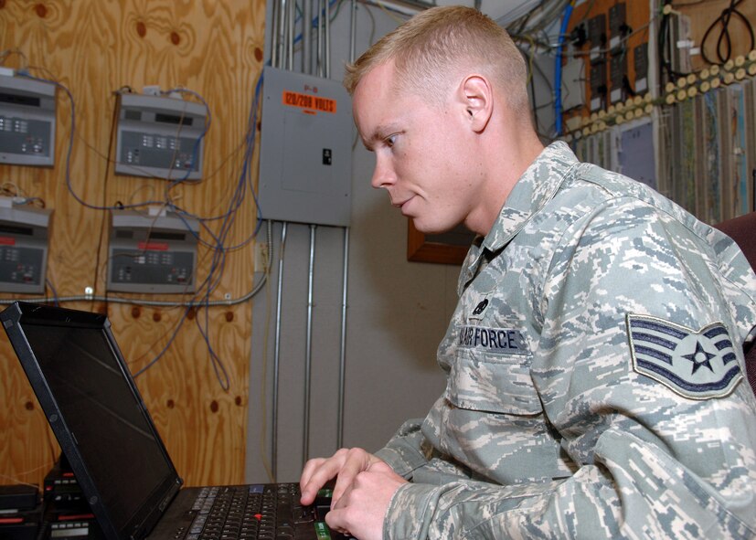 DYESS AIR FORCE BASE, Texas -- Staff Sergeant Nicholas Siburt troubleshoots the fire crash repeater, on a laptop, in the command post's frame room, March 25. The fire crash repeater keeps outside signals from interfering with the base's wireless radio network. (U.S. Air Force Photo by Airman 1st Class Micheal Breaux)