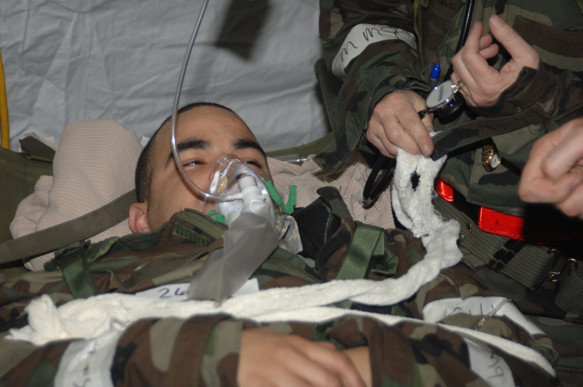 SEYMOUR JOHNSON AFB N.C. - Staff Sergeant Gerson Hernandez, 4th Support Squadron, being treated for wounds at the 4th Medical Group in Tent City after an attack during the Operational Readiness Exercise March 18, 2008 at Seymour Johnson AFB, N.C.  The exercise is To evaluate the 4 FW?s ability to survive and operate (ATSO), employ aircraft and resources, and conduct mission support activities in a steady state combat environment, and to provide training opportunities to improve on existing capabilities.  (U.S. Air Force photo by Senior Airman Chad Trujillo)