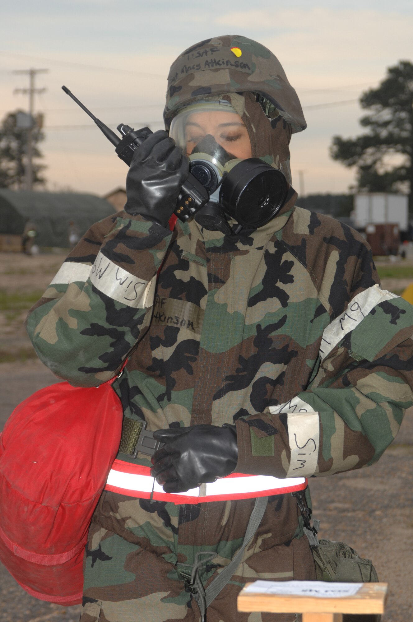 SEYMOUR JOHNSON AFB N.C. - Staff Sergeant Mary Atkinson, 4th Force Support Squadron, is part of Post Attack Reconnissance team radios in all clear after a sweep of the Clam Shell in Tent City during the Operational Readiness Exercise March 18, 2008 at Seymour Johnson AFB N.C.  The exercise is To evaluate the 4 FW?s ability to survive and operate (ATSO), employ aircraft and resources, and conduct mission support activities in a steady state combat environment, and to provide training opportunities to improve on existing capabilities.  (U.S. Air Force photo by Senior Airman Chad Trujillo)