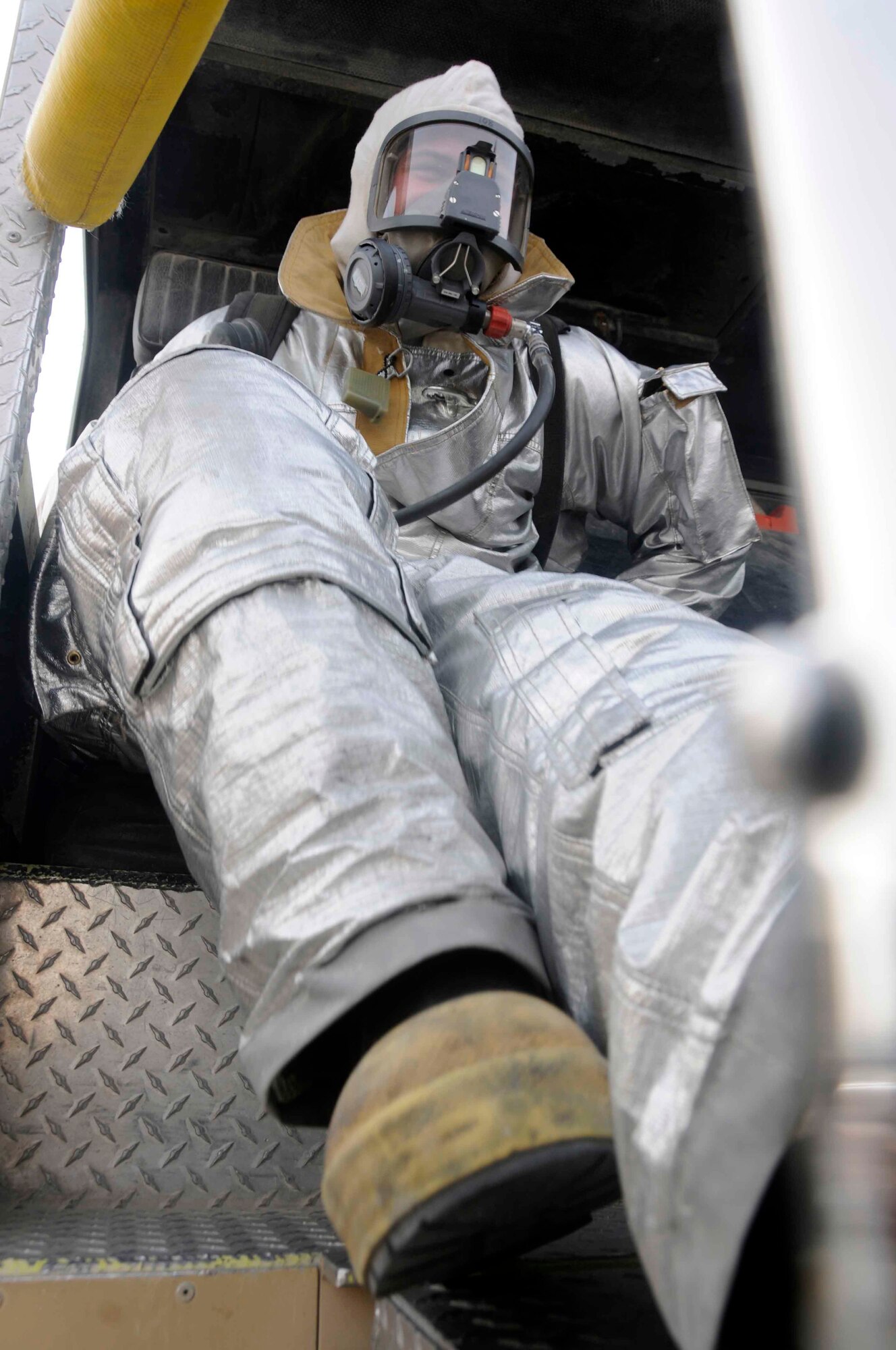 Senior Airman Thomas Mix, 379th Civil Engineer Squadron, responds to an alarm on top of a fire response vehicle.March 20. (U.S. Air Force photo/Senior Airman Domonique Simmons)
