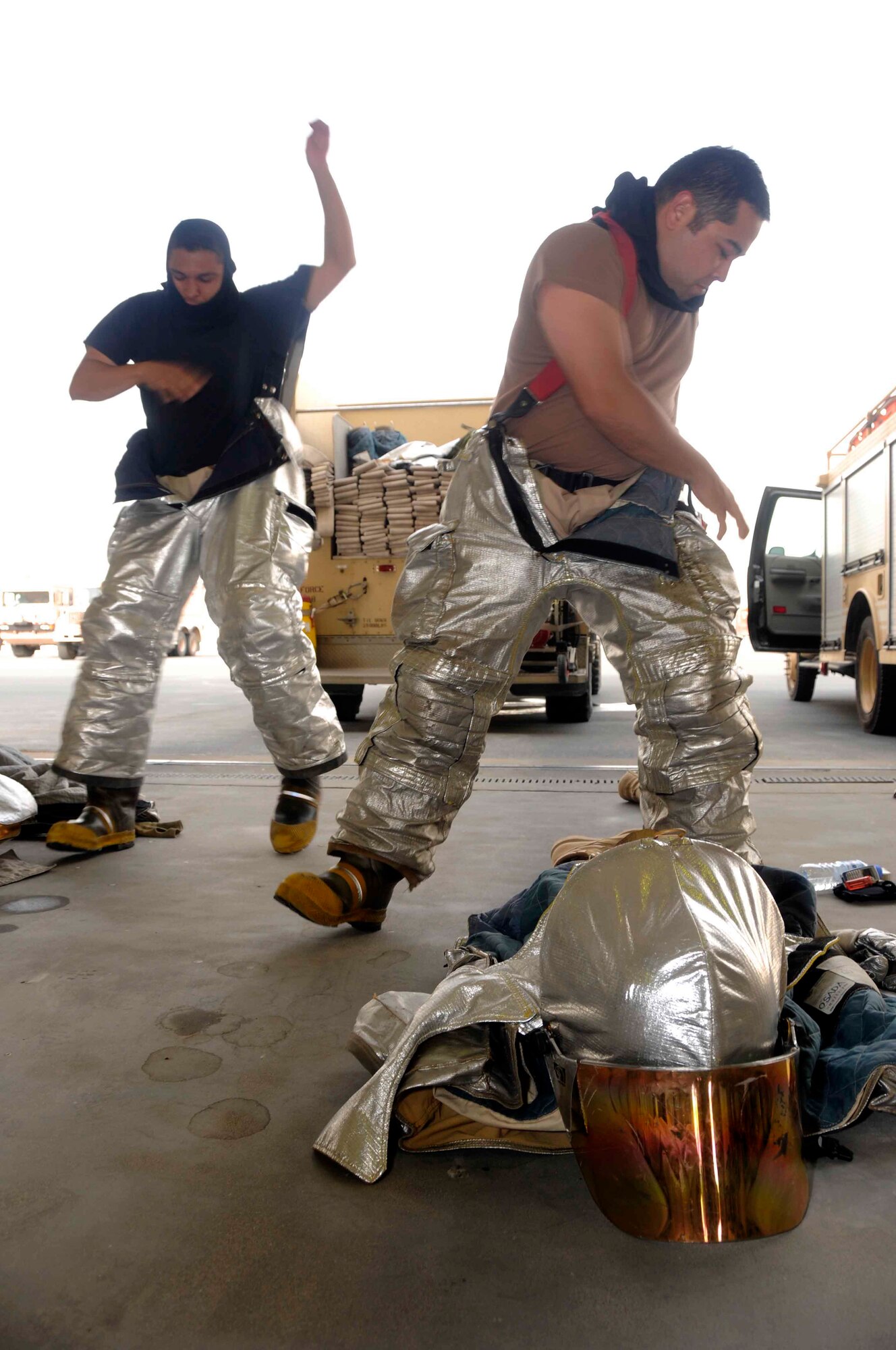 Staff Sgt. Juan Rodriguez and Staff Sgt. Michael Osada suit up in protective gear swiftly during a bunker exercise March 20. Both sergeants clocked a time of 45 seconds to get fully suited and prepared to respond to a possible alarm.(U.S. Air Force photo/ Senior Airman Domonique Simmons)