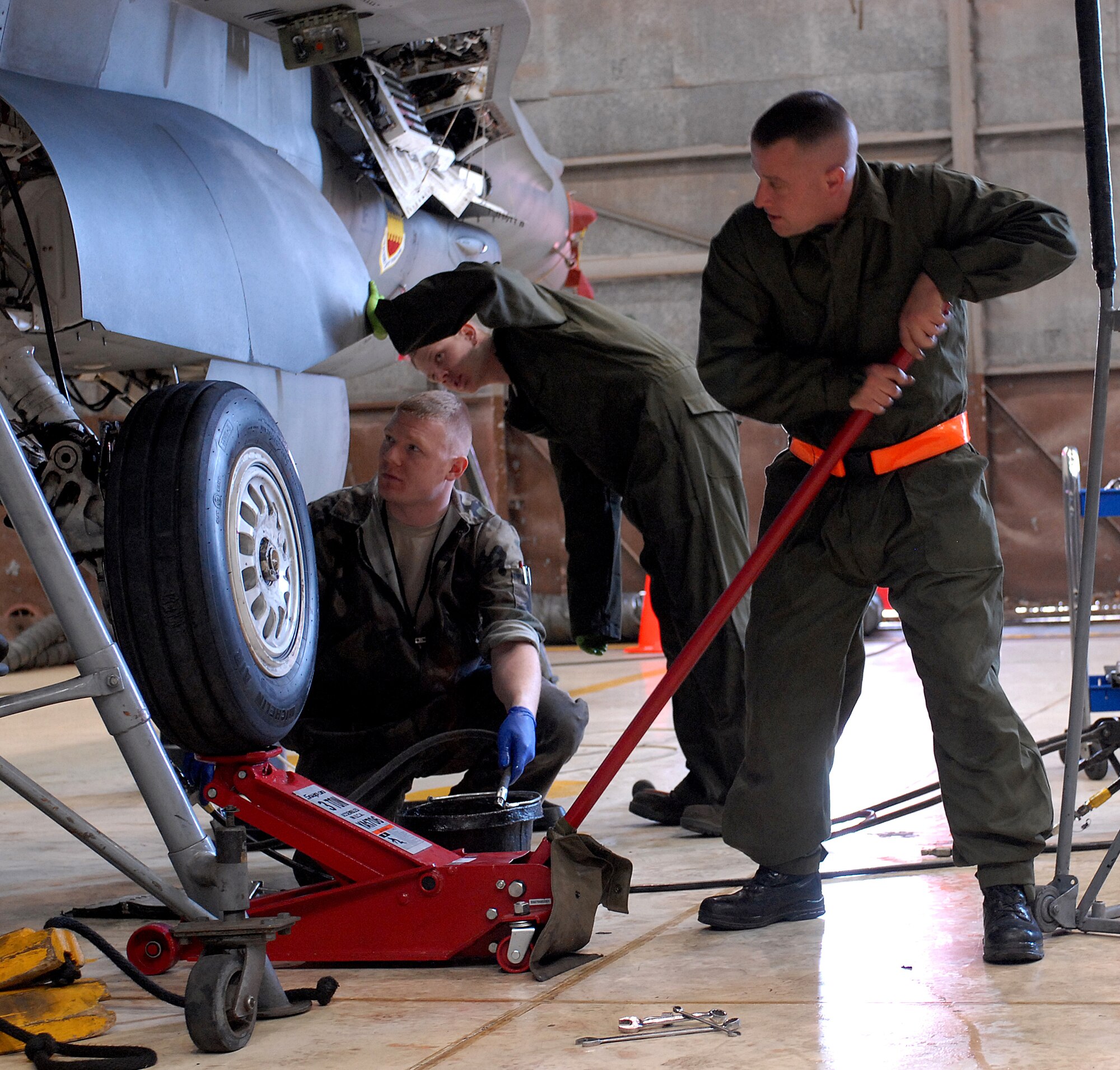 KUNSAN AIR BASE, Republic of Korea -- Staff Sgt. Daniel Shawn, Airman 1st Class Patrick Bayless and Staff Sgt. Lance Wade deployed from the 79th Expeditionary Fighter Squadron, perform phase inspection on an F-16 aircraft here March 25.  Every 400 hours, an aircraft goes through Phase Inspection, which extends its life span and prevents damages from day-to-day operation.  (U.S. Air Force photo/Senior Airman Giang Nguyen)