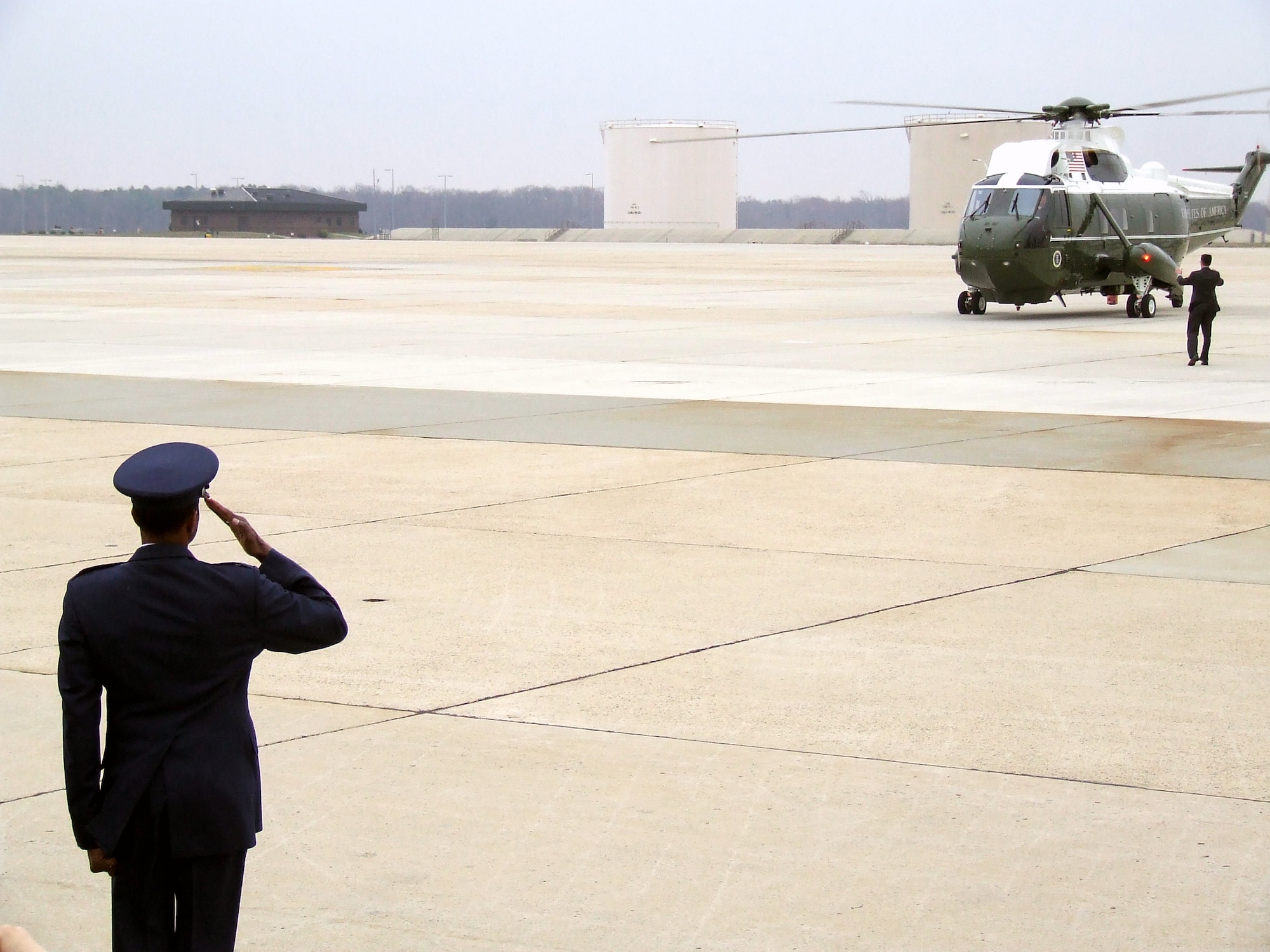 Col. Balan Ayyar, 305th Air Mobility Wing commander, salutes Marine One with President George Bush aboard as he arrives back to McGuire Air Force Base, N.J., after flying from the base to Freehold, N.J.  (U.S. Air Force Photo/Tech. Sgt. Scott T. Sturkol)