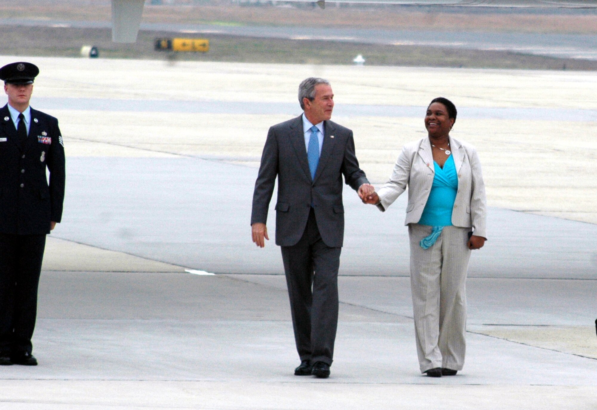President of the United States George Bush greets with Mrs. Andrell Reid, a military spouse, after arriving at McGuire Air Force Base, N.J., March 28, 2008.  Mrs. Reid received a presidential pin in recognition for outstanding volunteerism.  She is the spouse of Army Master Sgt. Raymond Reid of Fort Dix, N.J.  (U.S. Air Force Photo/Tech. Sgt. Scott T. Sturkol)