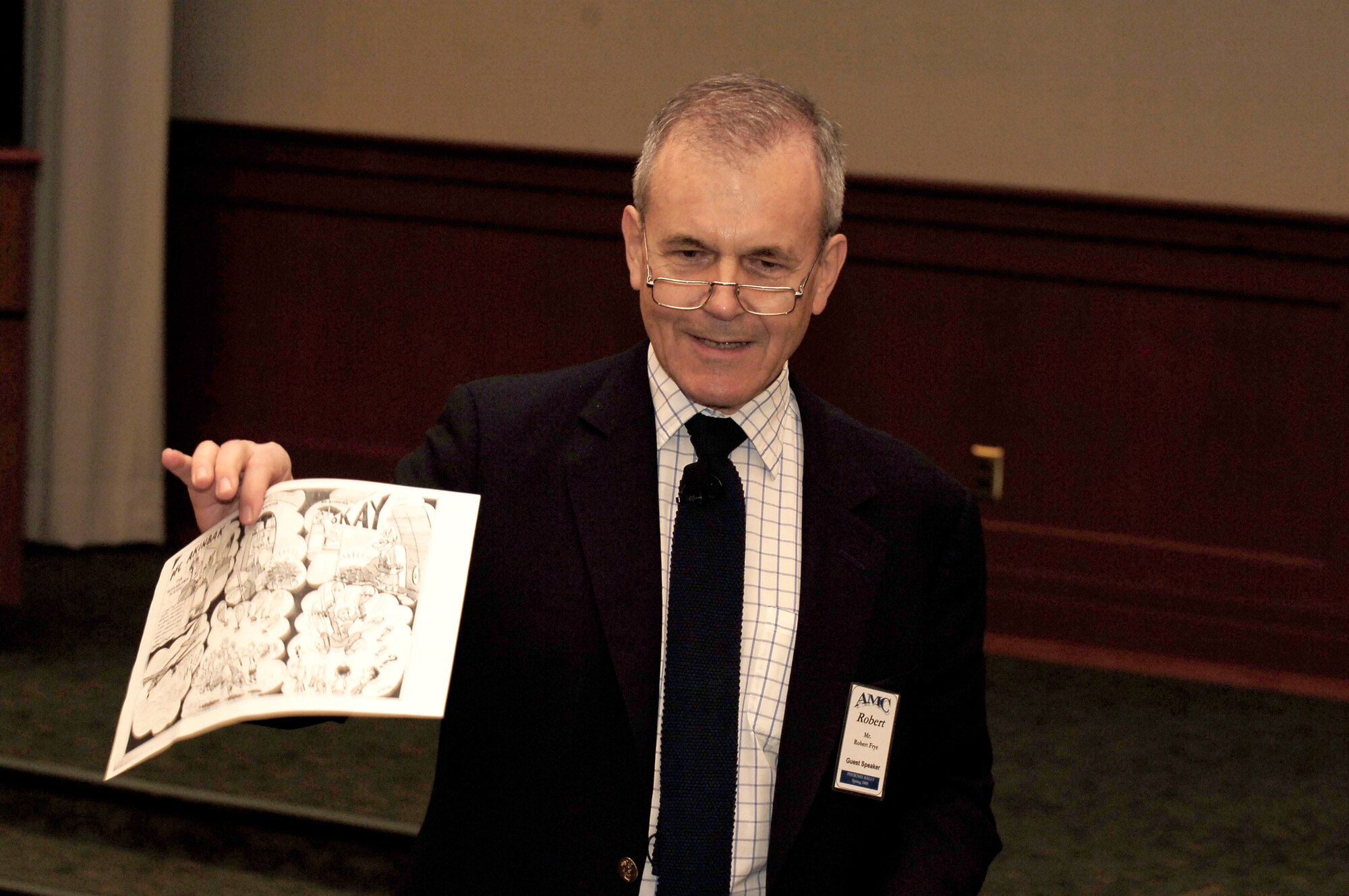 Robert Frye displays an old Task Force Times cartoon sketch of the Berlin Airlift from 1948 during the 2008 Phoenix Rally conference March 21 at MacDill Air Force Base, Fla. Mr. Frye spoke to Air Force leaders to commemorate the 60th anniversary of the Berlin Airlift.The purpose of the conference was to shape the Air Mobility Command as well as display the legacy of global reach and hope. Mr. Frye is an Emmy award winning producer. (U.S. Air Force photo/Senior Airman Bradley Lail) 
