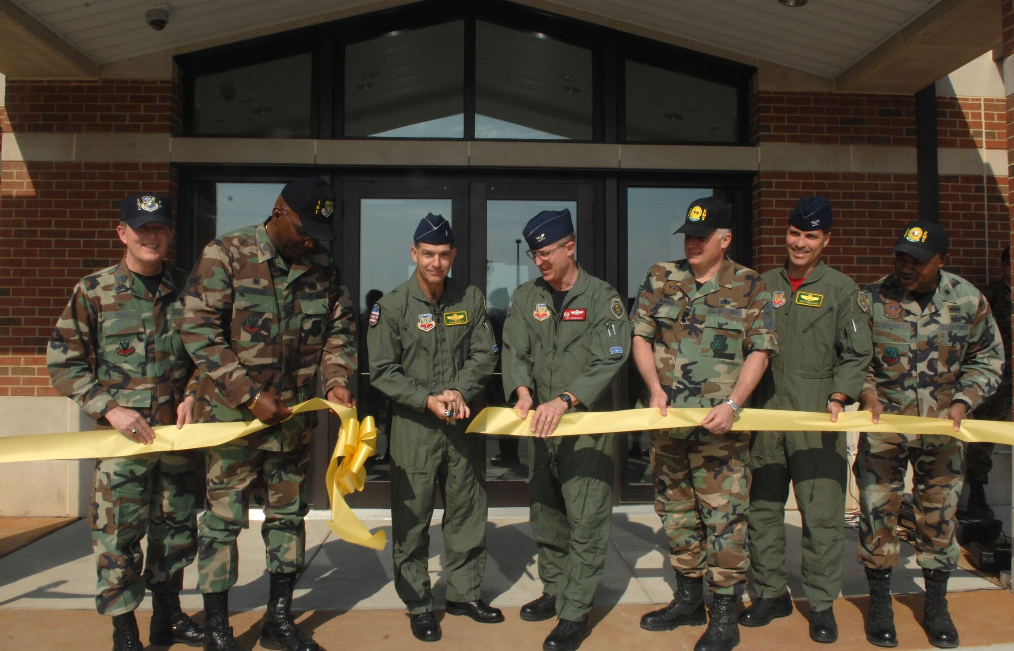 LANGLEY AIR FORCE BASE, Va. -- Brig. Gen. Mark Barrett, 1st Fighter Wing commander, cuts the ribbon to open the new 
munitions adminstrative support facility during a ceremony here March 28.  Ammunitions troops will work out of the new administrative building when not performing maintenance or inspections.  (U.S. Air Force photo/Senior Airman Cecil C. McCloud)