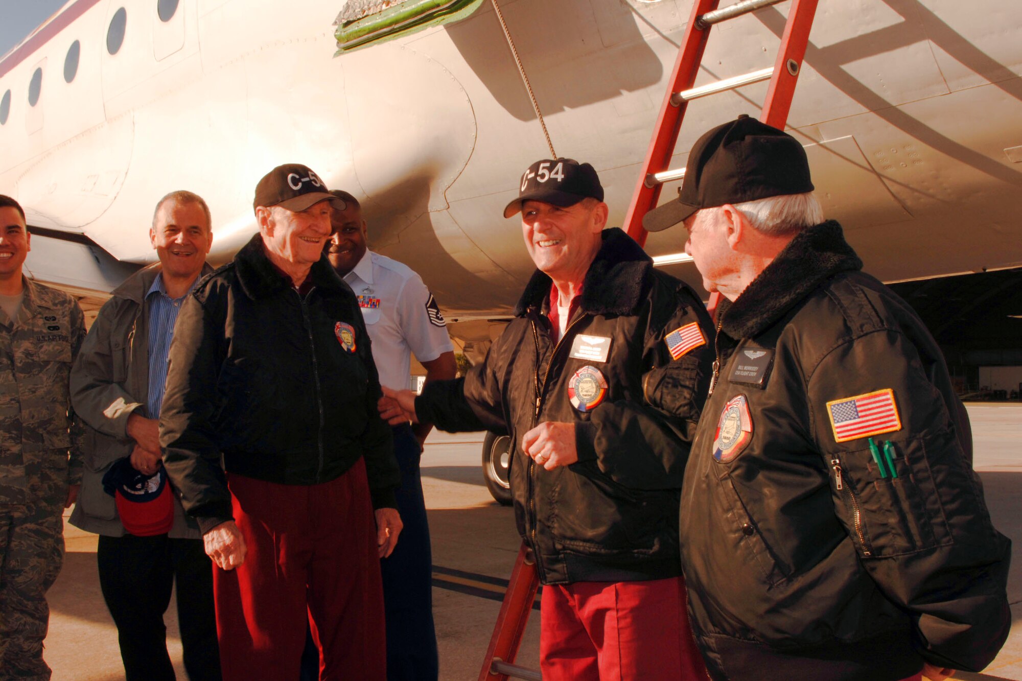 Retired Col. Gail Halvorsen (left to right), Tim Chopp and Bill Morrissey prepare to board a C-54 Skymaster March 24 at MacDill Air Force Base, Fla.  The three made up the crew of "Spirit of Freedom" a 1945 C-54E about to perform a fly over of Steinbrenner Field for a New York Yankees spring training game. (U.S. Air Force photo/Staff Sgt. Joseph Swafford)
