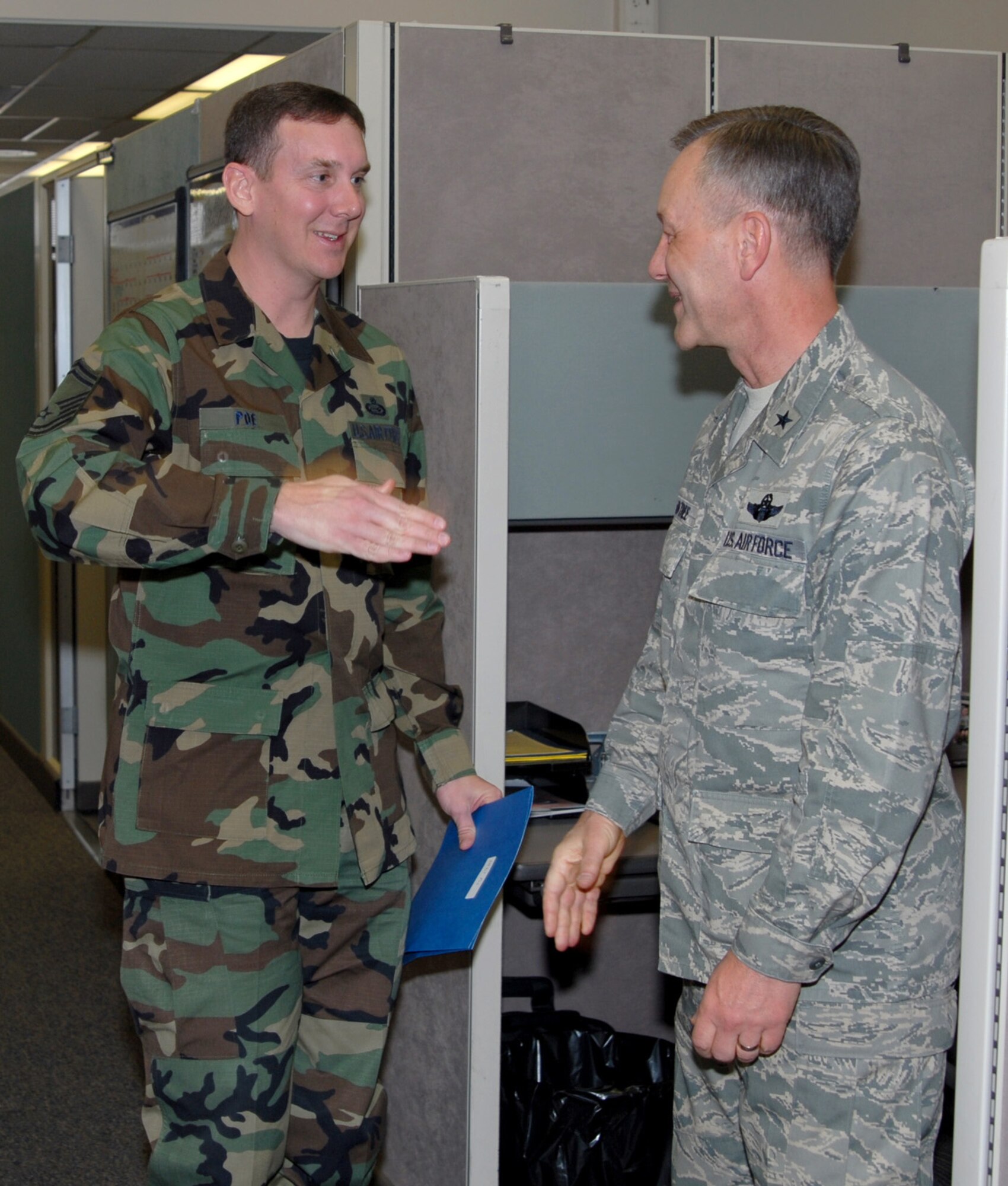 Senior Master Sgt. Robert Poe, DPA, salutes after being congratulated by Brig. Gen. Eric Crabtree, ARPC commander. Sergeant Poe is one of several ARPC Airmen who will be promoted at an official ceremony March 31. (U.S. Air Force photo/Ellen Edwards)
