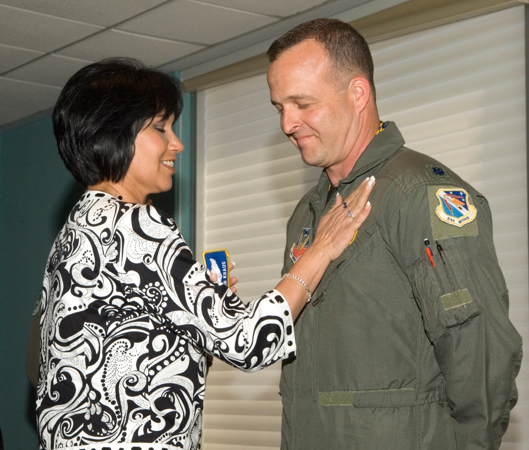 Lt. Col. Rob Kraus, newly appointed 68th Electronic Warfare Squadron commander, is congratulated by his wife Joanne, March 27 at the change of command ceremony at the officers club at Eglin Air Force Base, Fla.  He took the reins of the 68th from Lt. Col. Gene Anderson.  Courtesy photo.