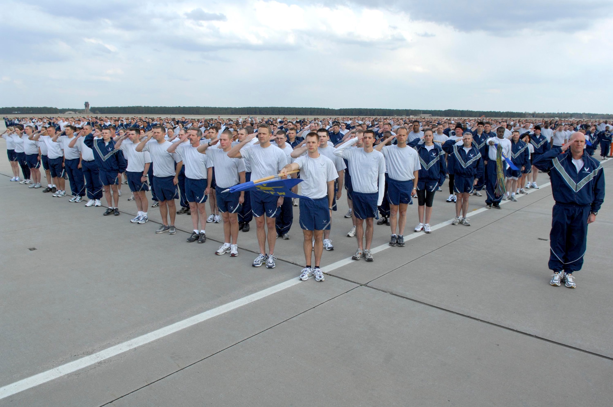 SHAW AIR FORCE BASE, S.C.-- Col. James Post, 20th Figher Wing commander, leads a large portion of the Wing's, more than 4500, active duty members in a salute as the American flag is lowered at retreat prior to a 3.1 mile valor run on the flight line recently. The valor run promotes wing-wide esprit de corps and camaraderie.  Physical fitness is a key factor in maintaining air expeditionary readiness. (U.S. Air Force photo/Tech. Sgt. Josef Cole III)