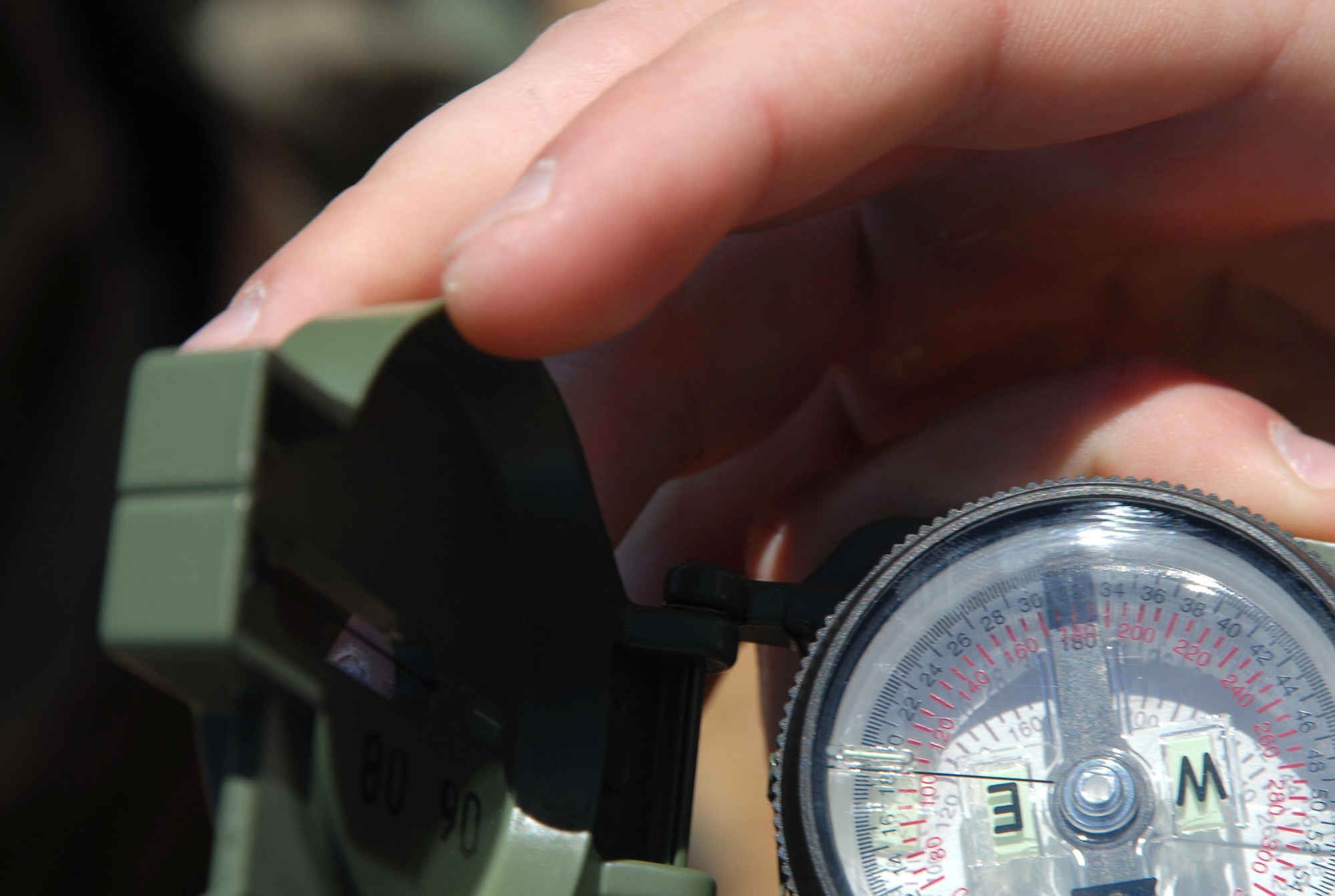 Airman with the 95th Medical Group used compasses to look for the right direction during land navigation training here March 26. The training included basic understanding of compass use, topographical features, grid coordinates and distance approximation using pace counts. (Air Force photo by Senior Airman Julius Delos Reyes)