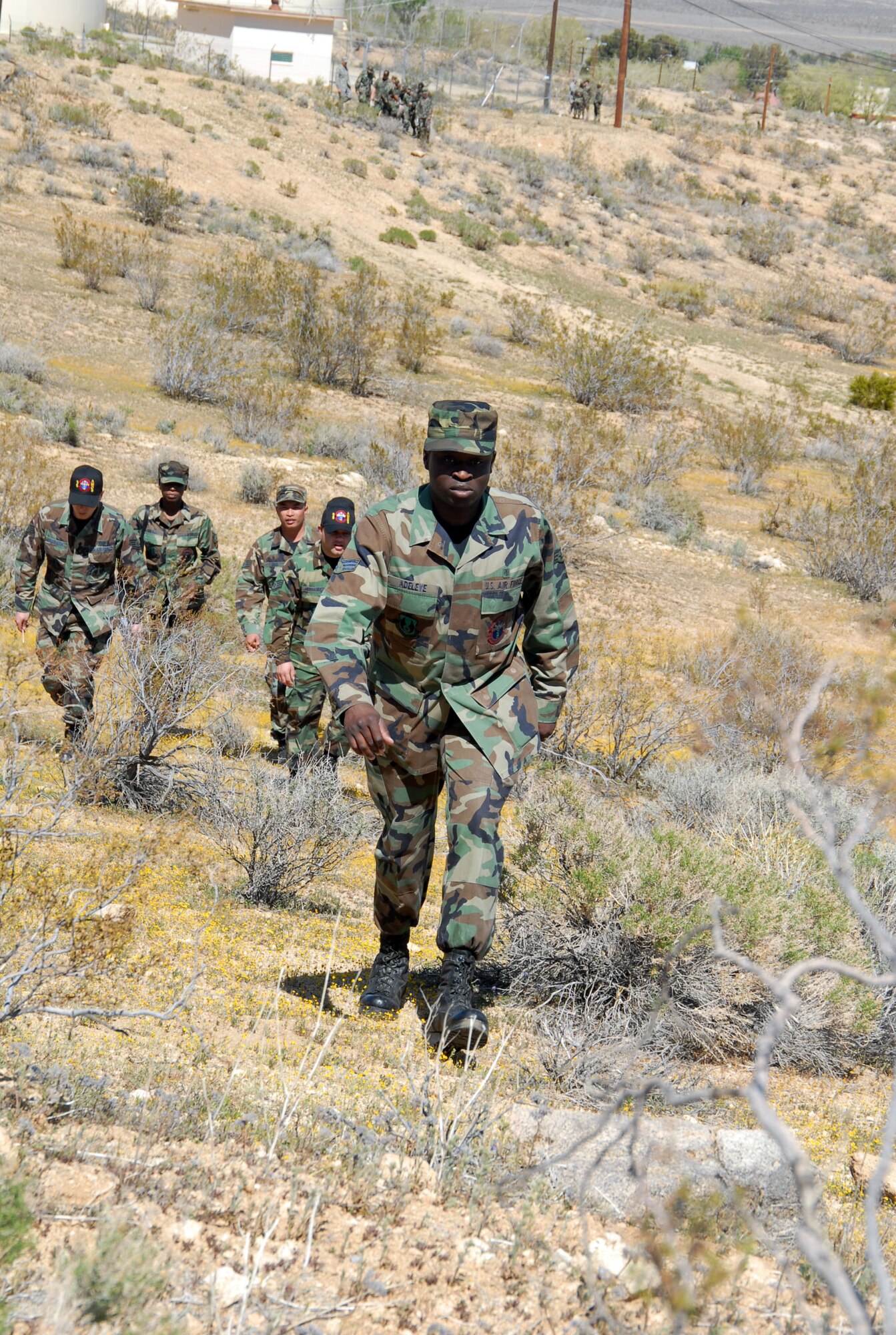 Senior Airman Alexander Adeleye, 95th Aerospace Medical Squadron bioenvironmental engineer, leads his team during land navigation training March 26. The training included basic understanding of compass use, topographical features, grid coordinates and distance approximation using pace counts. (Air Force photo by Senior Airman Julius Delos Reyes)