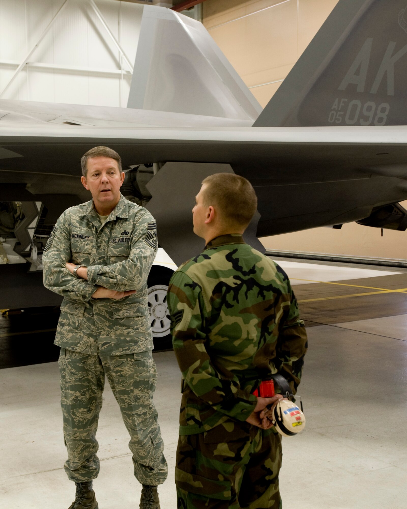 ELMENDORF AIR FORCE BASE, Alaska -- Senior Airman Alexander Buck, 90th Aircraft Maintenance Unit, explains his job as a crew chief for the F-22 Raptor to Chief Master Sergeant of the Air Force Rodney McKinley here March 27. Chief McKinley has been on a tour to meet Airmen around the Pacific Air Forces. (U.S. Air Force photo by Airman 1st Class Jonathan Steffen) 