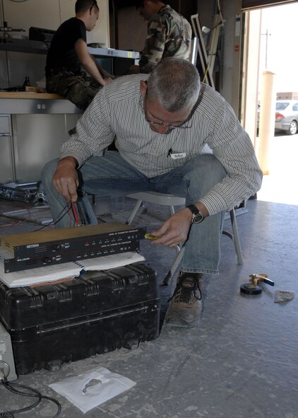 Mr. Dan McKee, superintendent of base radio, resets  a trunking system at Holloman Air Force Base, N.M., March 24, 2008. This system transmits and receives a lot of signals on a few frequencies. (U.S. Air Force photo by Airman 1st Class Rachel A. Kocin)