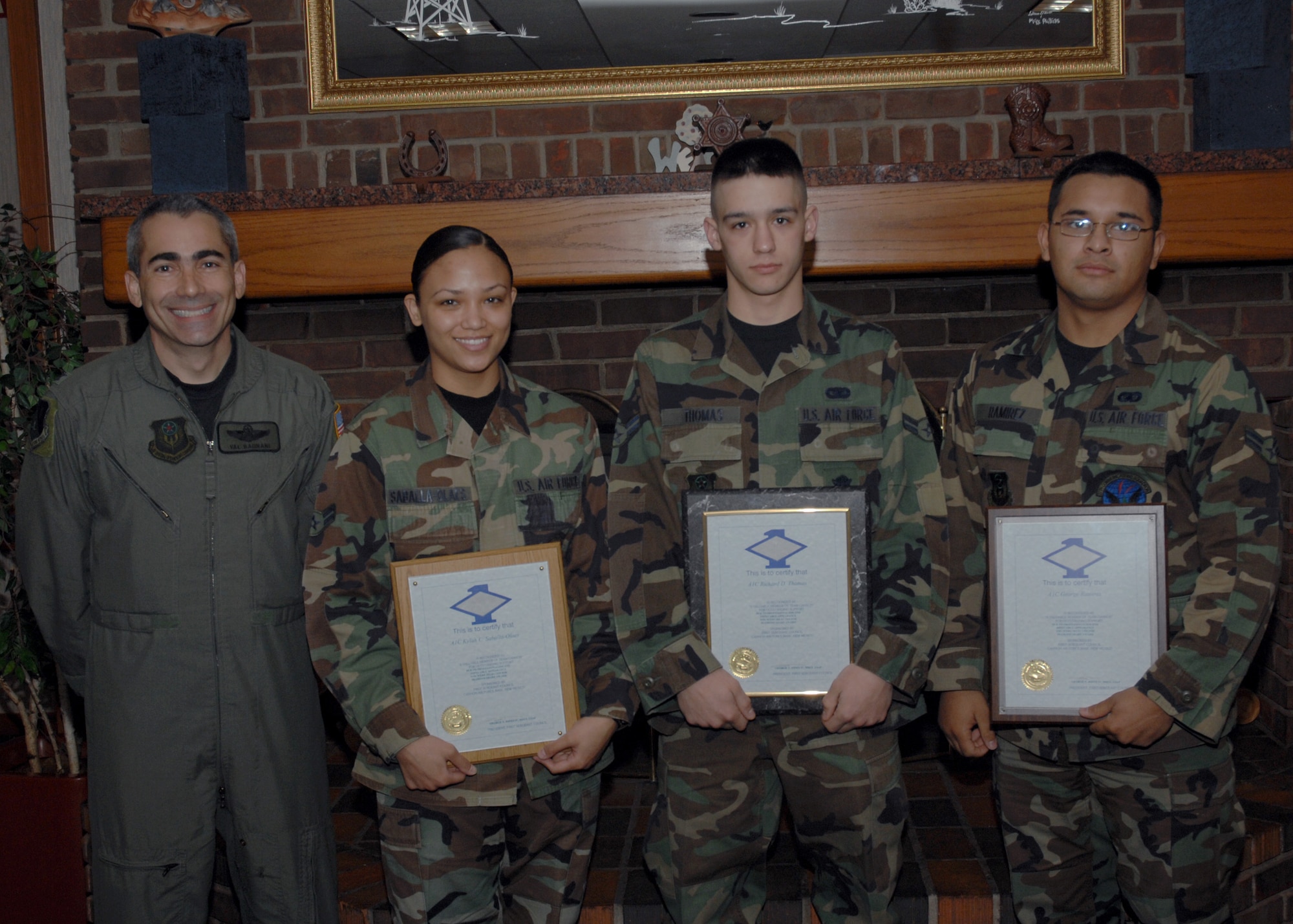 CANNON AIR FORCE BASE N.M. - (left to right) Col. Valentino Bagnani III, 27th Special Operations Wing vice commander, stands next to Airman 1st Class Kylah Saballa-Olaes, 27th Special Operations Support Squadron, Airman 1st Class Richard Thomas, 27th Special Operations Security Forces Squadron, and Airman 1st Class George Ramirez, 27th Special Operations Communications Squadron, who received the Diamond Sharp award at the Pecos Trail Dinning Facility March 28.  Airmen are given diamond sharp for exellence both on and off-duty.  (U.S. Air Force photo by Airman 1st Class James R. Bell)
