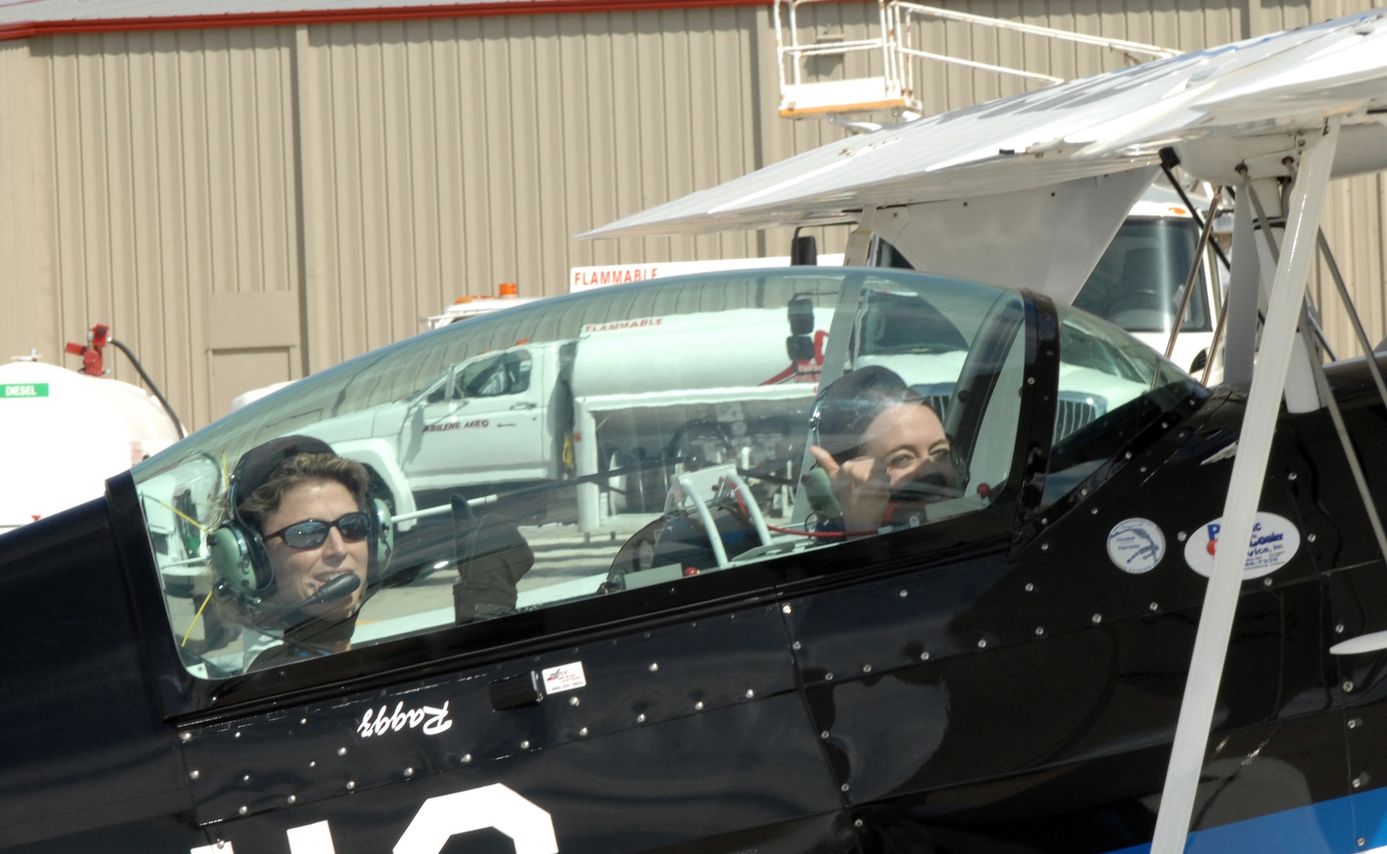 DYESS AIR FORCE BASE, Texas -- Sarah Varble, Abilene Reporter News Videographer, gives a thumbs up before her media flight in the Ragged Edge, March 22. The Ragged Edge is an aerobatic aircraft that will be performing at the Big Country Airfest on May 3rd, 2008. (U.S. Air Force photo by Senior Airman Courtney Richardson) 