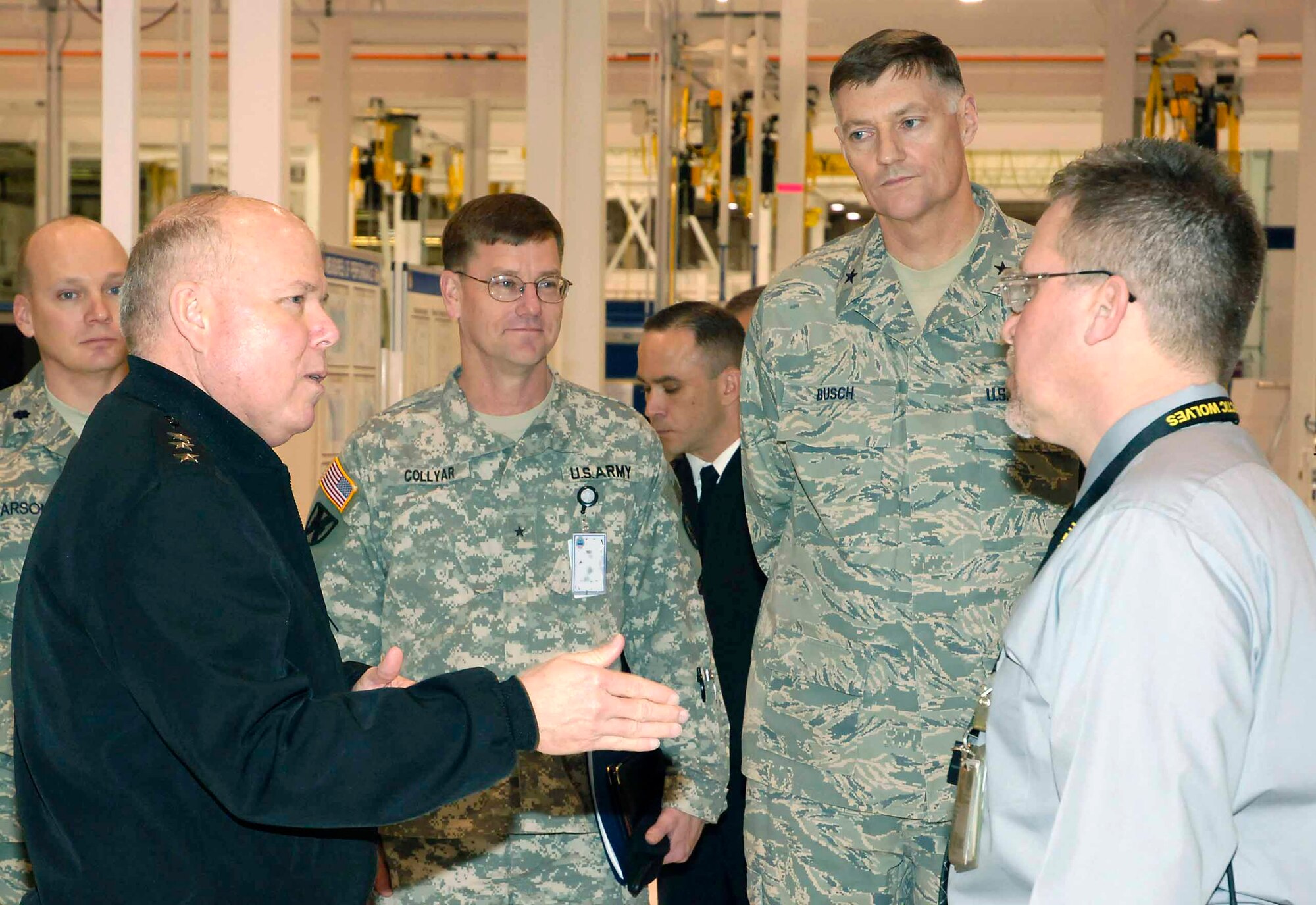 Army Lt. Gen. Robert Dail visited DLA Oklahoma City and the Oklahoma City Air Logistics Center at Tinker Air Force Base March 21. During the visit he spoke to Richard Robinson from the 76th Maintenance Wing, Propulsion Group, as Lt. Col. Kelly Larson (left), commander of DLA Oklahoma City,  Brig. Gen. Lynn Collyar (center), commander of Defense Distribution Center, and DSCR Commander Brig. Gen. Andy Busch (right), listen.  (Air Force photo by Dave Faytinger) 