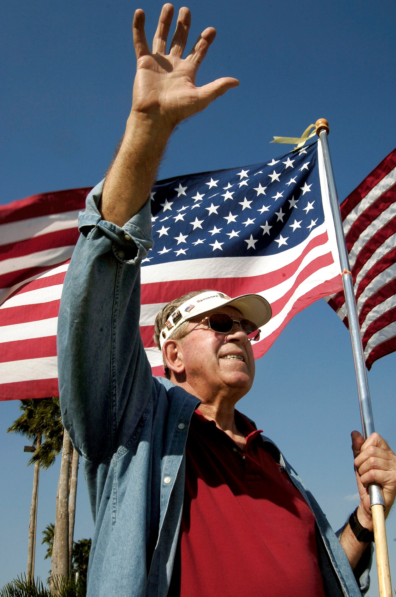 Paul Diehl shows his patriotism to members March 21 at MacDill Air Force Base, Fla. Mr. Diehl is a member of the Bayshore Patriots in Tampa. The patriots show their support to military members and their families by waving the American flag on one of the busy roads in Tampa. They consist of retired military and civilian members of the community.  (U.S. Air Force photo/Senior Airman Bradley Lail)