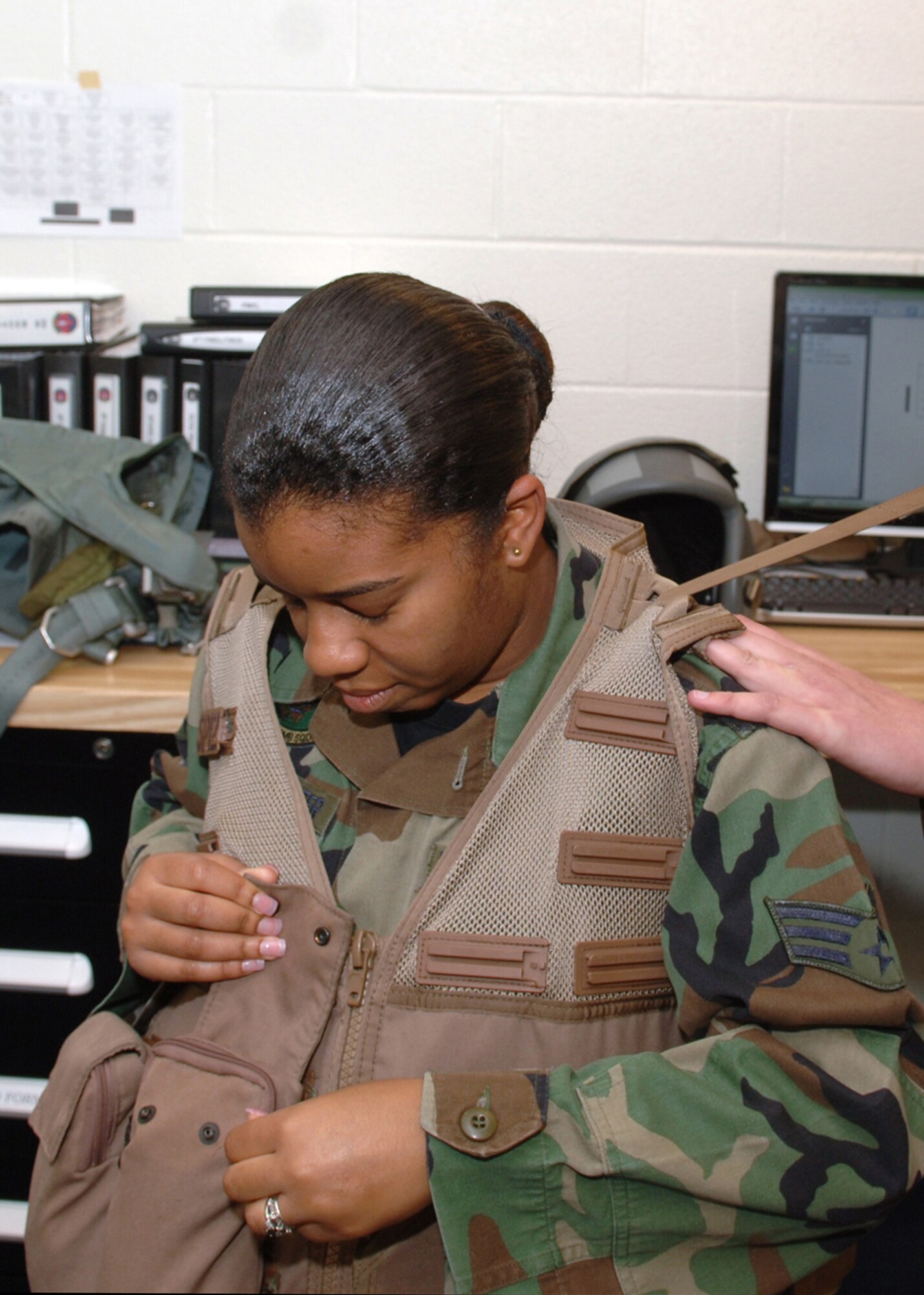 DYESS AIR FORCE BASE, Texas -- Senior Airman Crystal Hanna-Poindexter gets fitted for a survival vest prior to her incentive flight, March 27. The survival vest is equiped with flares, a compass, water, a first aid kit and various other useful items. (U.S. Air Force Photo by Airman 1st Class Micheal Breaux)