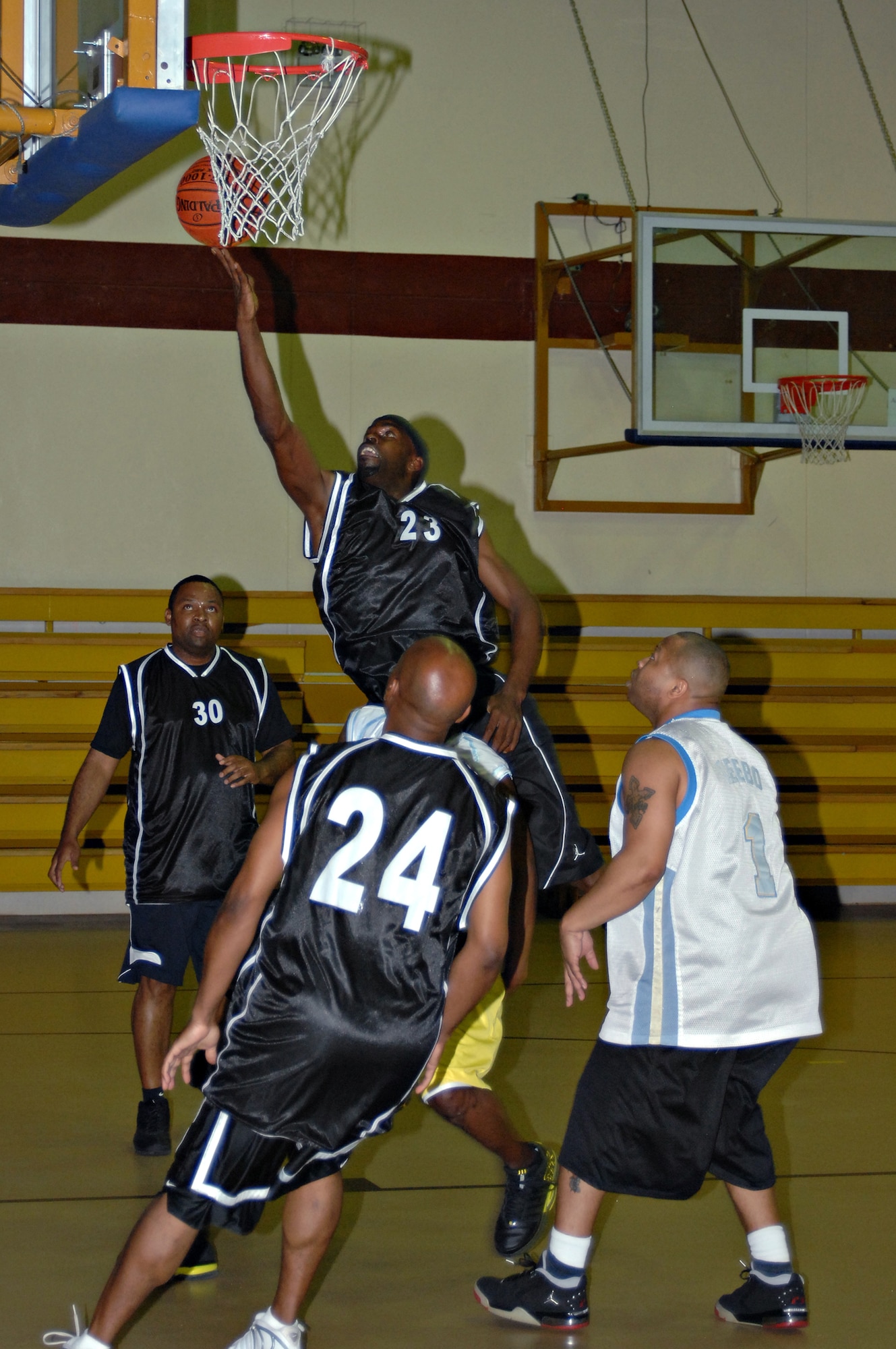 Rob Smith, 39th Civil Engineer, Mission Support and Services Squadron combined basketball team, scores a layup during the Over-30 Championship by beating the 39th Logistics Readiness Squadron team, 65-47. Smith helped lead CES/MSS/SVS to victory with 17 points during the game. (Photo by Airman 1st Class Benjamin Wilson.)