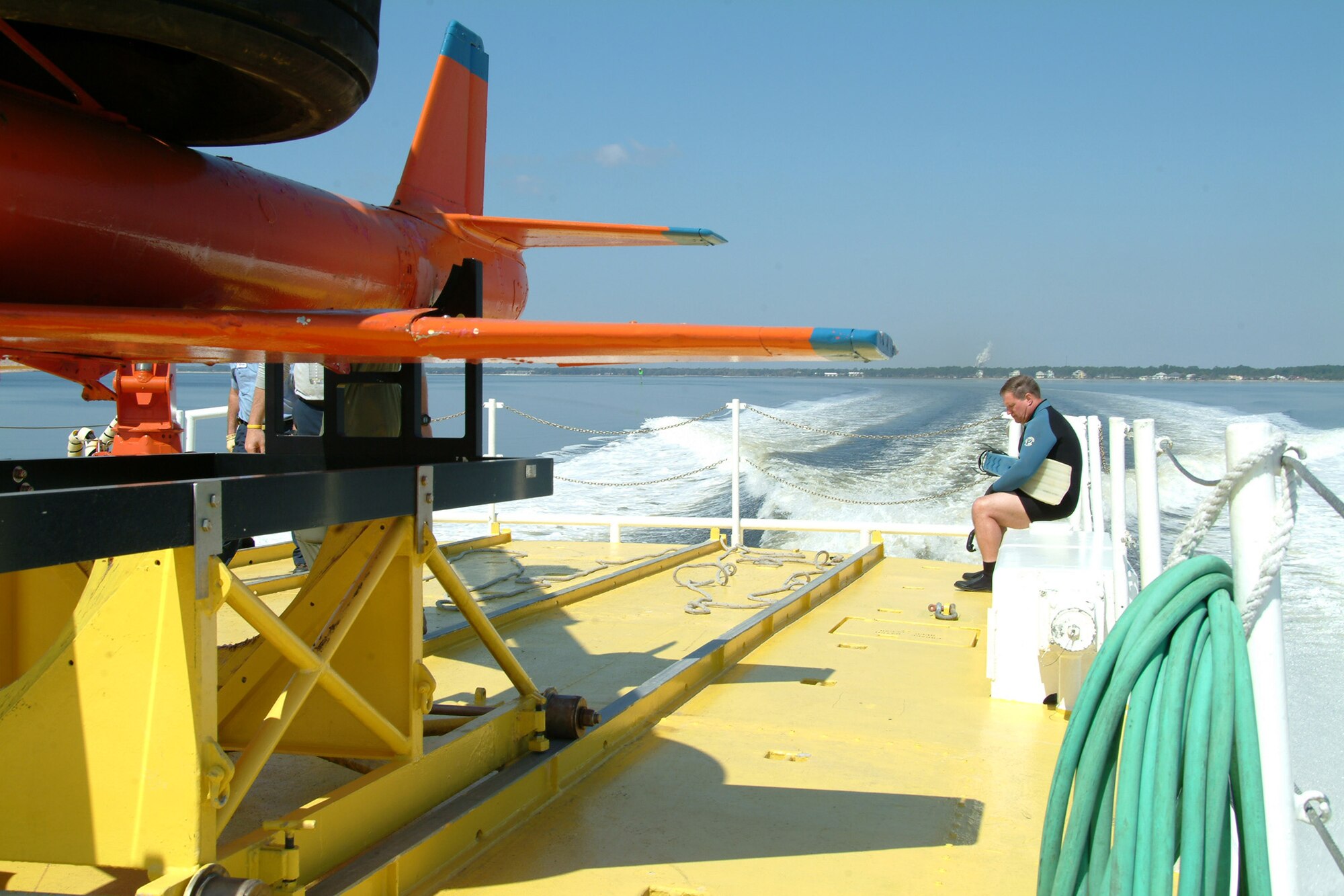 Steve Shafer prepares his wetsuit before going into the waters of the Gulf of Mexico to demonstrate the sub-scale drone recovery process March 26 at Tyndall Air Force Base, Fla.  The ship used for recovery is one of only three 120-foot boats owned by the Air Force.  They are contracted from Florida Offshore through the 82nd Aerial Targets Squadron to help recover sub-scale drones after they are shot down during live fire exercises.  Photo by Staff Sgt. Samuel King Jr.