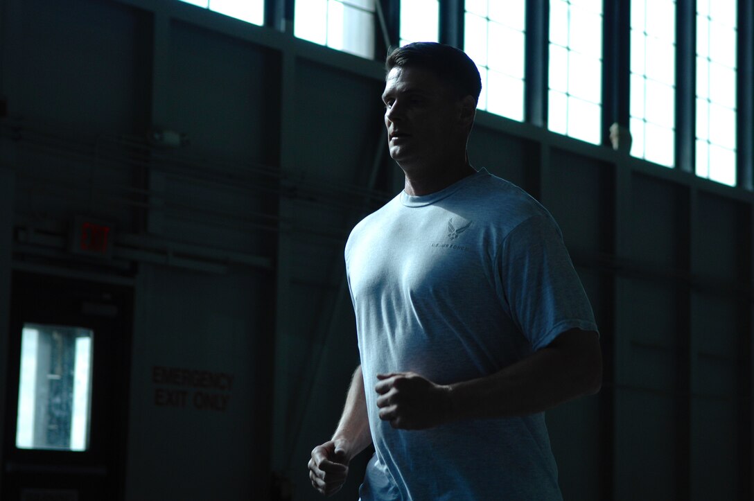 Master Sgt. Ronald Heller, 28th Operations Support Squadron intelligence flight superintendent, runs the track at the Pride Hanger during a group physical training session March 20. Sergeant Heller lost the lower half of one leg due to cardiovascular blood complications, but gained a renewed vigor for his outlook on life. (U.S. Air Force photo by Staff Sgt. Michael B. Keller)