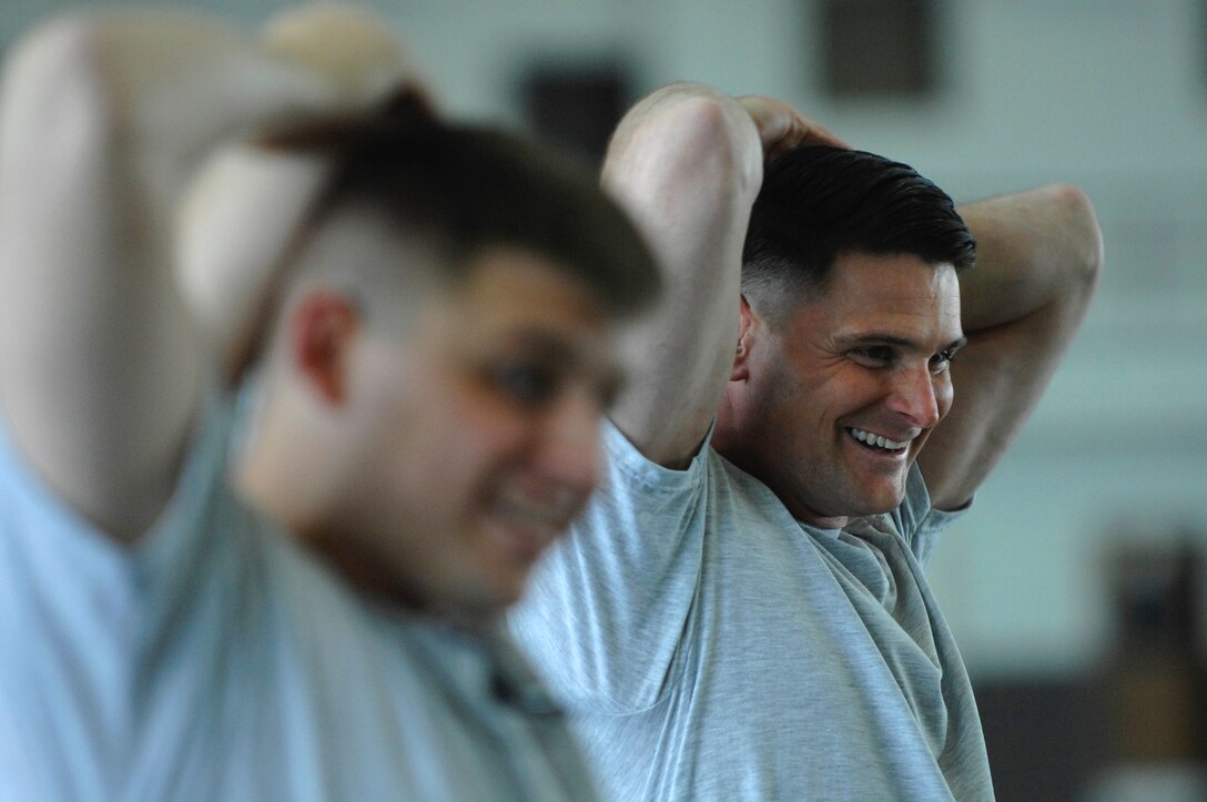 Master Sgt. Ronald Heller, 28th Operations Support Squadron intelligence flight superintendent, stretches with his coworkers during a group physical training session at the Pride Hanger March 20. Sergeant Heller lost the lower half of one leg due to cardiovascular blood complications, but gained a renewed vigor for his outlook on life. (U.S. Air Force photo by Staff Sgt. Michael B. Keller)