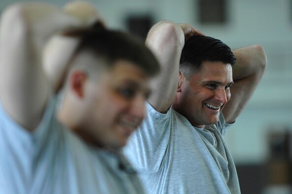 Master Sgt. Ronald Heller, 28th Operations Support Squadron intelligence flight superintendent, stretches with his coworkers during a group physical training session at the Pride Hanger March 20. Sergeant Heller lost the lower half of one leg due to cardiovascular blood complications, but gained a renewed vigor for his outlook on life. (U.S. Air Force photo by Staff Sgt. Michael B. Keller)