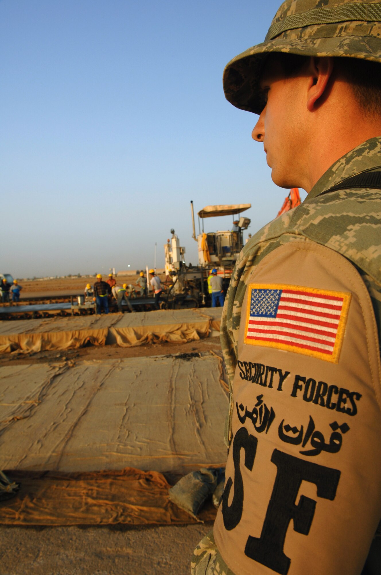 Airman 1st Class Jonathan Wohlford watches over third country national workers March 24 at a construction site at Balad Air Base, Iraq. Keeping an eye out for any compromising activities is a critical job to keep Airmen safe. (U.S. Air Force photo/Senior Airman Julianne Showalter)