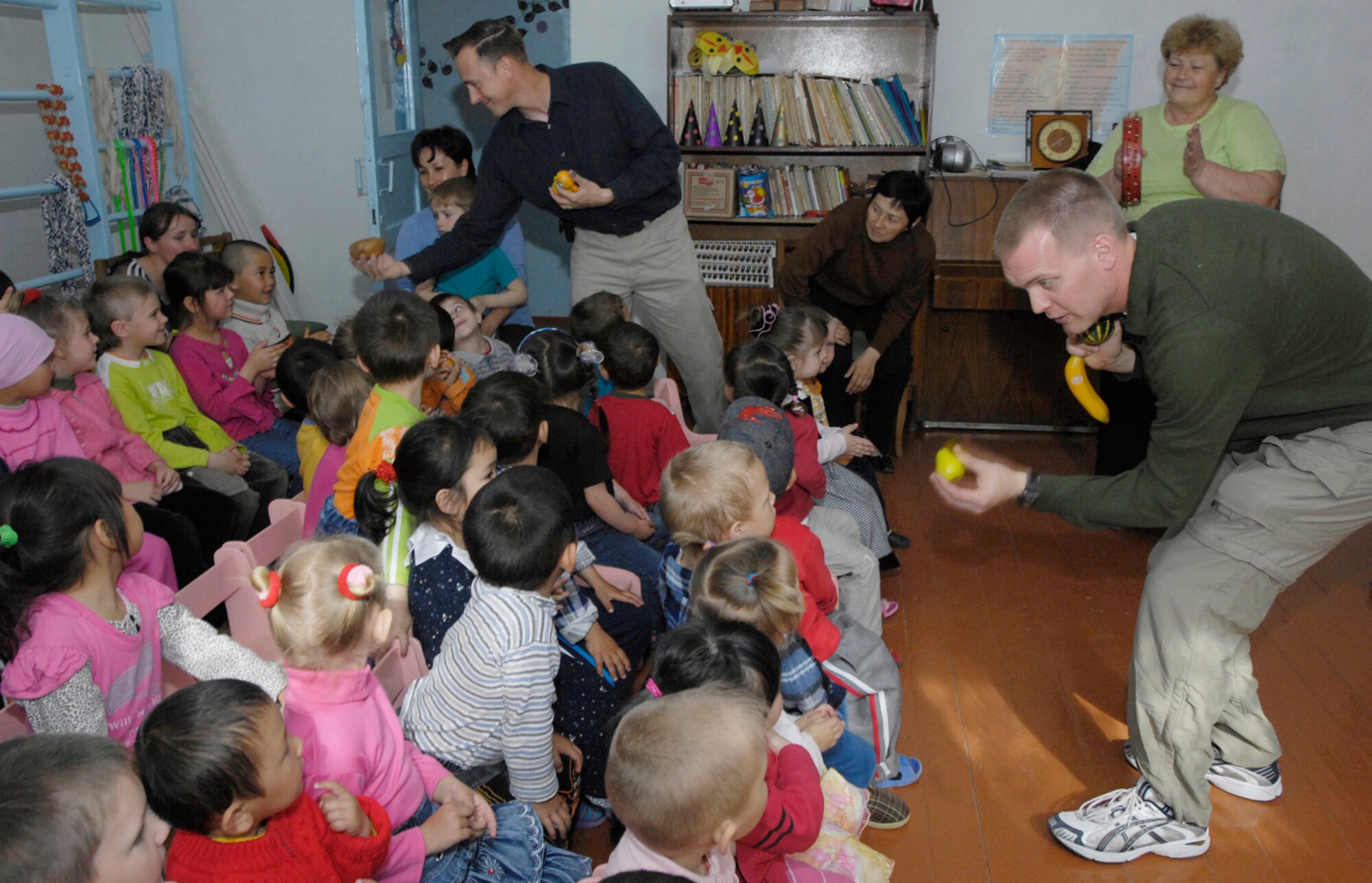 Staff Sergeant Peter Dahlstrom and Master Sergeant Rick Thorp, members of the U.S. Central Air Forces Band "Hot Brass,"  had out musical fruits and vegetables the students at the village school in Vasilievka, Kyrgyzstan on March 26, 2008. Band members took the time to introduce the students to every instrument before putting them together in harmony to make music.  "Hot Brass" performed for Manas Air Base Airmen and local villages and schools during six-day Kyrgyzstan leg of their Central Command area of responsibility tour. (Air Force photo by Senior Airman Tabitha Kuykendall) 
