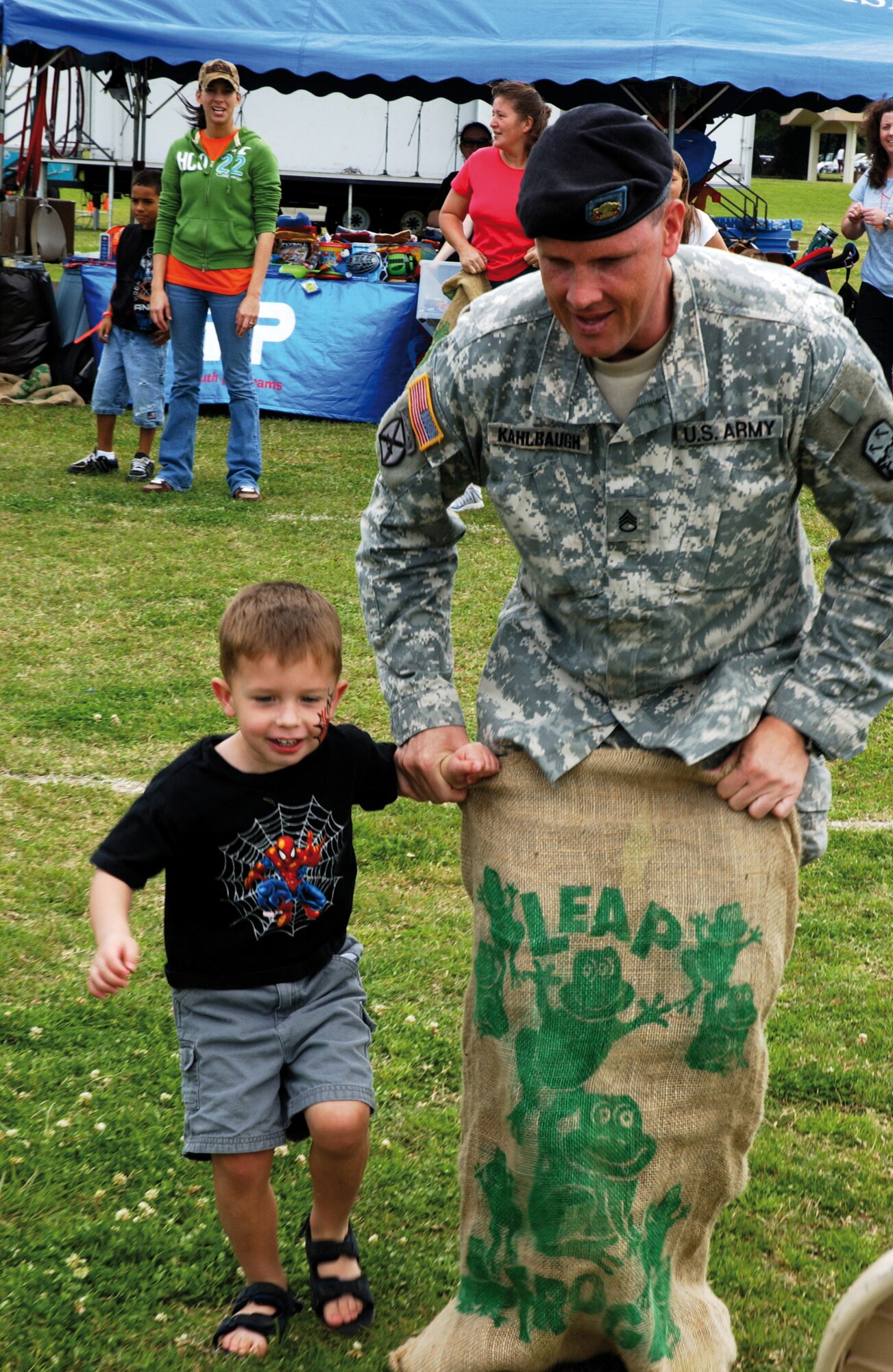 Staff Sgt. Joseph Kahlbaugh, Echo Company 1-1 Air Defense Artillery, and his son Hunter, compete in the sack race during the 2008 Spring Fest, March 22. Every year Kadena Services hosts the festival to usher in the new year and before kids are dismissed from school for spring break.               
(U.S. Air Force photo/Senior Airman Jeremy McGuffin) 
