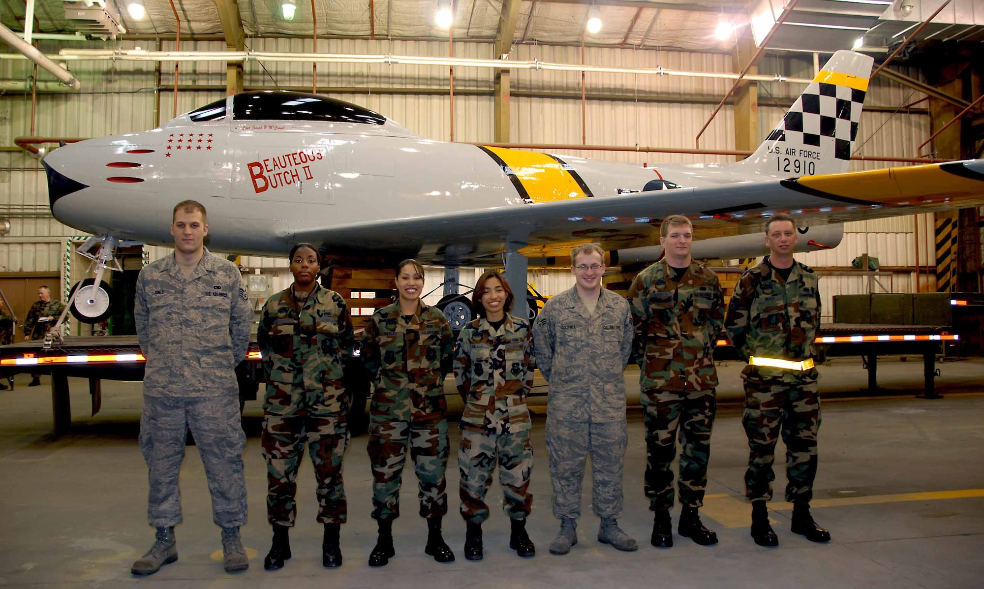 OSAN AIR BASE, Republic of Korea -- From left to right: Staff Sgt. Robert Jones, Senior Airman Johnetta Gray, Senior Airman Yeleen Neeley, Senior Airman Lisa Caluag, Senior Airman Paul Cotrill, Senior Airman William Crews and Tech. Sgt. Douglas Beals, stand in front of Osan's historic F-86 Sabre static display aircraft after its restoration and a new "checkertail" paint scheme. The aircraft will be displayed in front of Base Operations. All Airmen are aircraft structural technicians from the 51st Maintenance Squadron. (U.S. Air Force photo/Senior Master Sgt. Marvin Krause) 