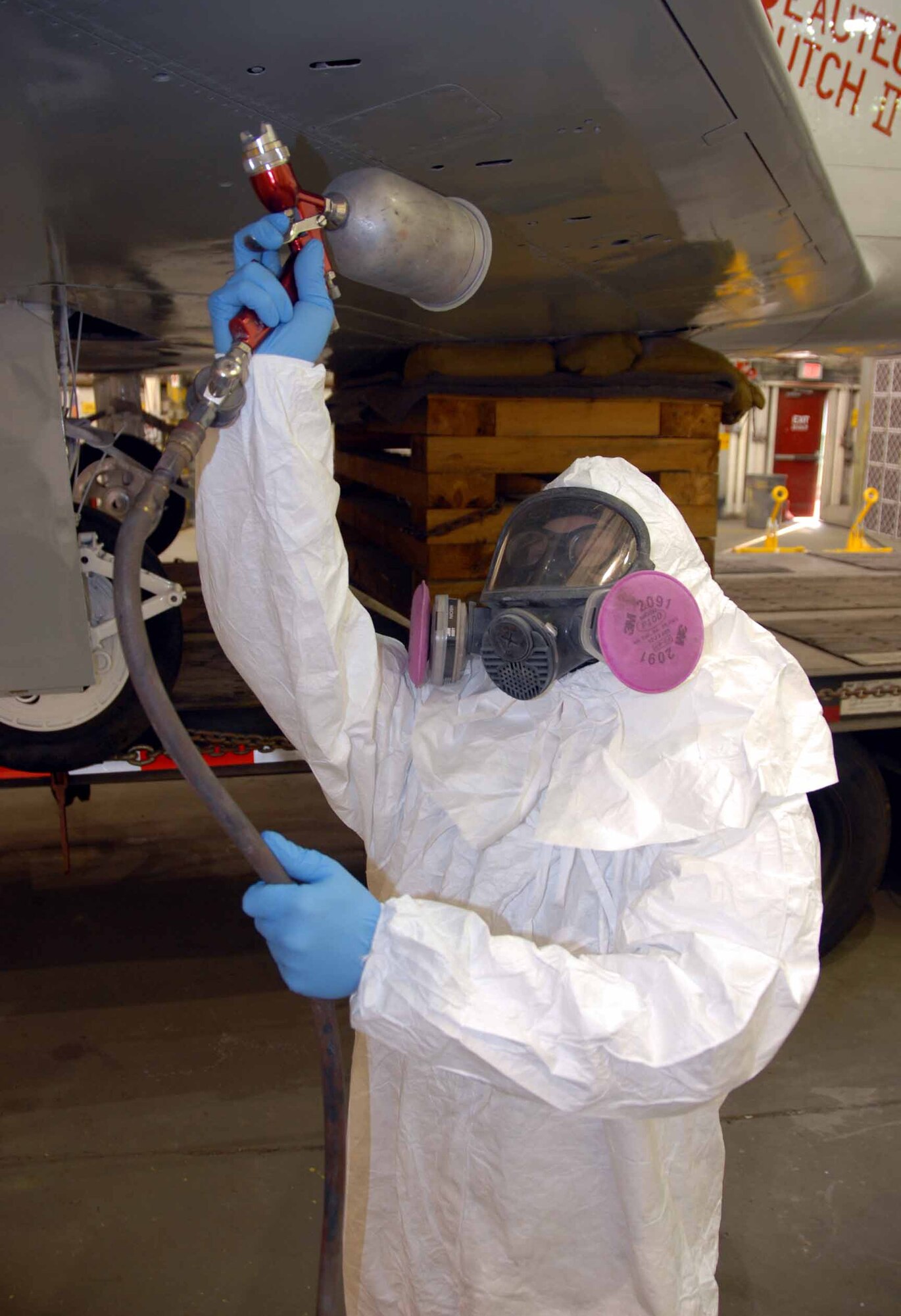 OSAN AIR BASE, Republic of Korea -- Senior Airman Paul Cotrill, 51st Maintenance Squadron aircraft structural technician, paints Osan's historic F-86 Sabre static display aircraft during its restoration and new "checkertail" paint scheme. (U.S. Air Force photo/Senior Master Sgt. Marvin Krause)  