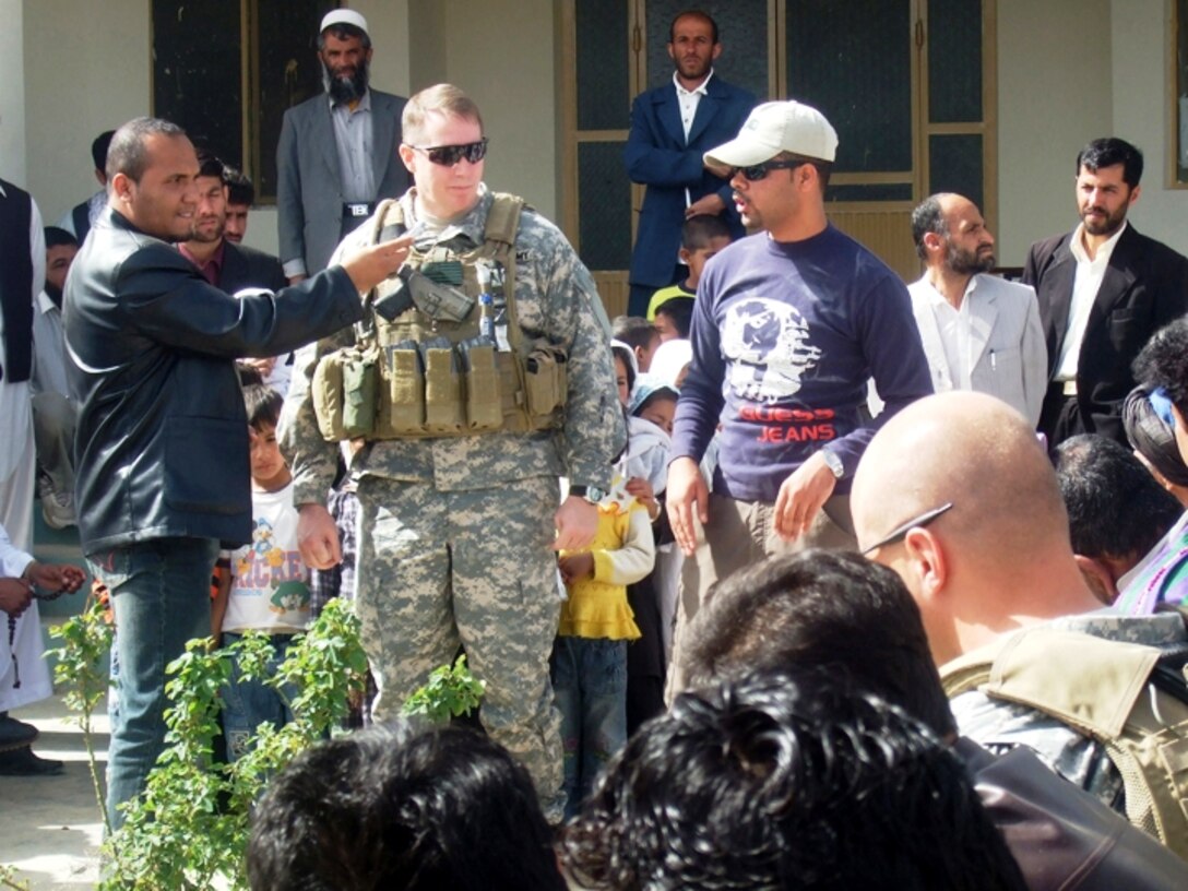 Army Lt. Col. Kenneth Watson speaks to a crowd gathered in front of Jan Qadam elementary school during the first day of class March 24, 2008. Village elders, Ministry of Education officials and coalition soldiers gathered to celebrate the first day of school and to dedicate the new school library and science lab. Photo by Staff Sgt. Marie Schult, USA