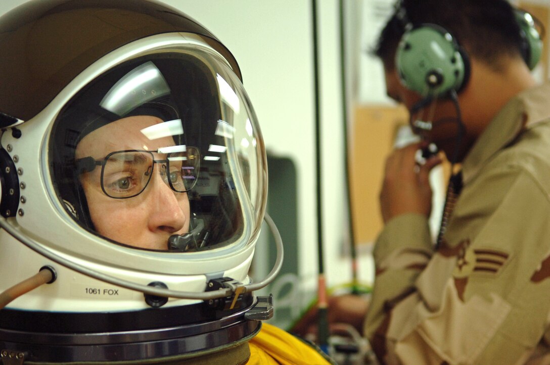 Air Force Capt. Heather Fox, a U-2 Dragon Lady pilot with 99th Expeditionary Reconnaissance Squadron, receives 100 percent oxygen in preparation for a mission while Senior Airman Roric Ongaco, 99th ERS physiological support division technician, monitors her suit pressure at a base in Southwest Asia, March 25, 2008. Fox is one of only three woman U-2 pilots currently serving in the Air Force. Photo by Senior Airman Levi Riendeau, USAF

