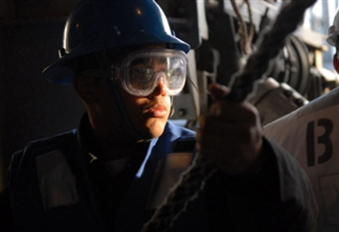 U.S. Navy Seaman Paul Blanco holds tension on a line aboard the USS Ronald Reagan (CVN 76) during a replenishment at sea with the USNS Yukon (T-AO 202) while underway in the Pacific Ocean on March 26, 2008.  The Ronald Reagan Carrier Strike Group is conducting a composite training unit exercise in preparation for an upcoming deployment.  