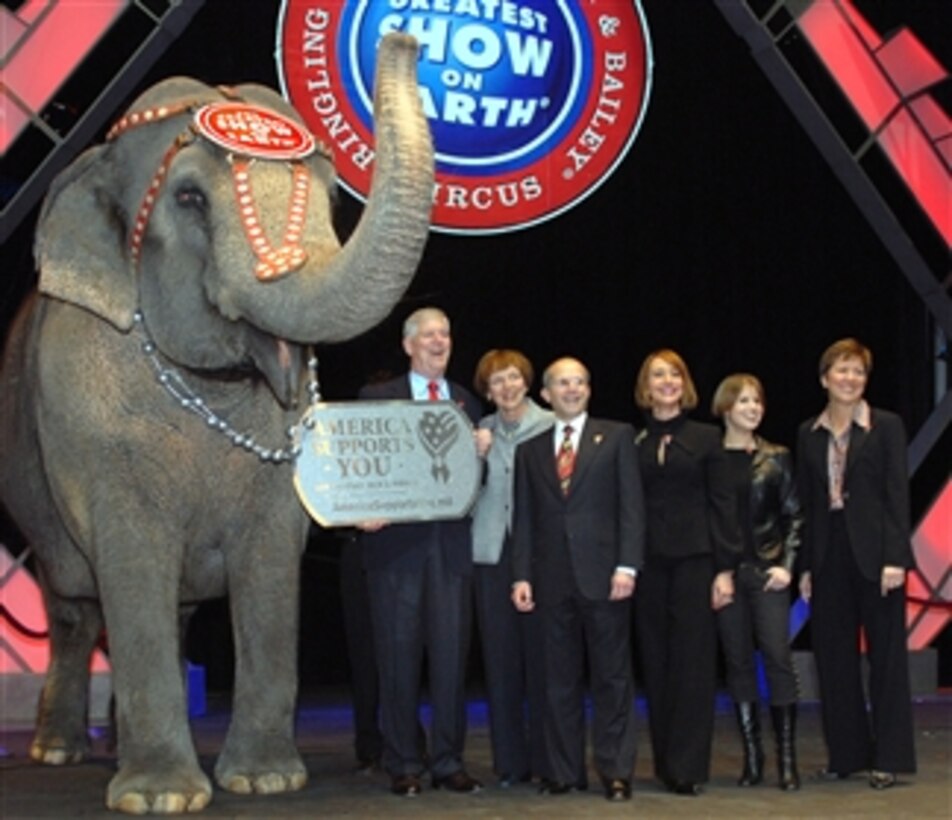 Asia, one of Ringling Bros. and Barnum and Bailey Circus’ elephants, shows her support of the military by sporting an America Supports You dog tag, held by former chairman of the Joint Chiefs of Staff retired Air Force Gen. Richard B. Myers. The duo was joined by, from left, Mary Jo Myers, Kenneth Feld, chairman of the circus, his wife Bonnie and daughter Nicole Feld, and Allison Barber, deputy assistant secretary of defense for internal communications and public liaison. 