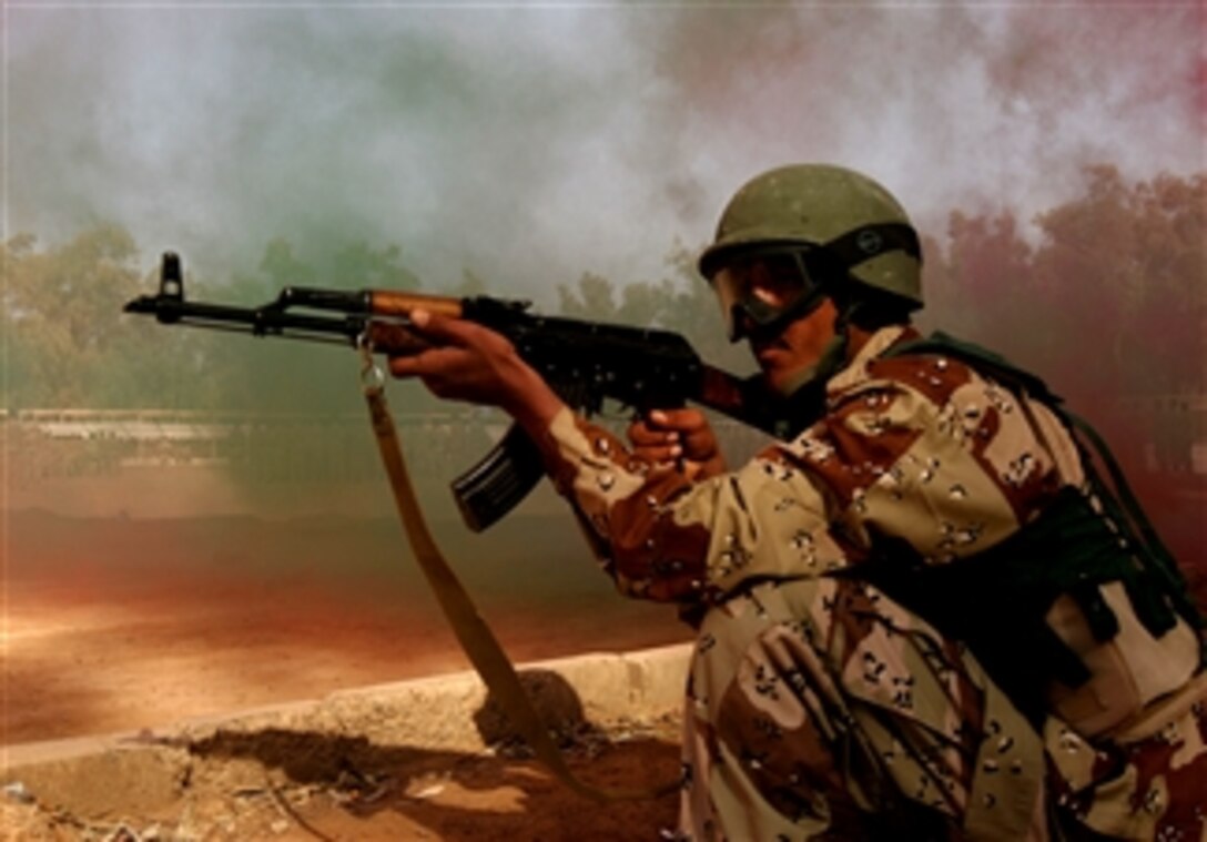 An Iraqi soldier sets up a security perimeter during the Iraqi Army's 4th Brigade, 7th Division's tactical exhibition at the end of a six-week training course with U.S. Marines, March 9, 2008.  