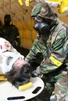 Cpl. Matthew Dunkle and Lance Cpl. Donnie Hoffman, Company B, Chemical Biological, Incident Response Force, II Marine Expeditionary Force, finish decontaminating a simulated casualty during a training exercise here March 29. CBIRF Marines and sailors trained here, honing their skills on operating in a contaminated area.