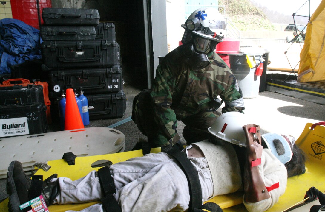 Lt. Cmdr. Jean Murray, a nurse corps officer with Headquarters and Service Company, Chemical Biological Incident Response Force, II Marine Expeditionary Force, treats a simulated casualty affected by a nerve agent here March 29. Corpsmen and doctors with CBIRF treat casualties of a chemical, biological, radiological, nuclear, or high-yield explosive incident, both in the contaminated area and after they are decontaminated.