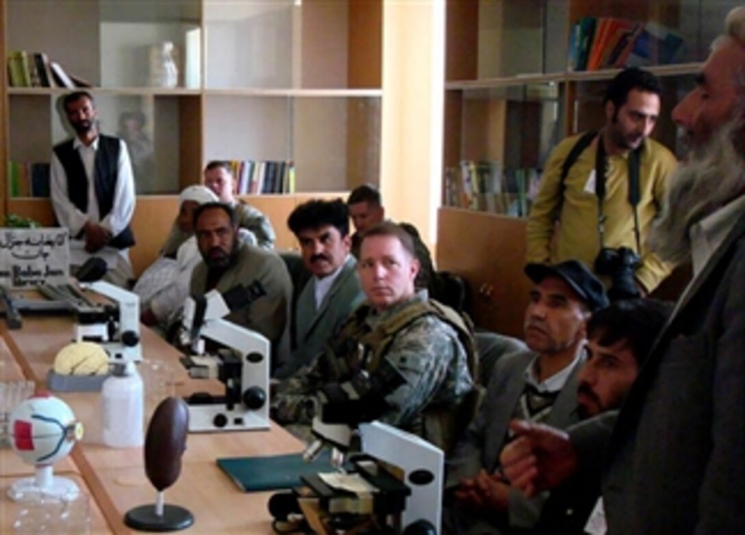 U.S. and coalition troops meet with Afghan education officials and village elders in the library and science lab of the Jan Qadam Elementary School during the school's opening day in Bagram, Afghanistan, March 24, 2008. The library was dedicated to Gen. Baba Jan, who donated the land for the school.
