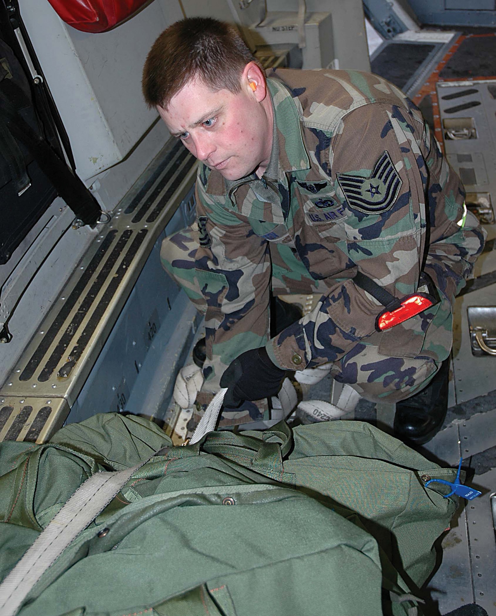 Tech. Sgt. Ray Green wanders through the cargo bay of a C-17 on the lookout  for anything out of place such as tools, garbage, or loose cargo.  (U.S. Air Force photo/Airman First Class Patrick Cabellon)