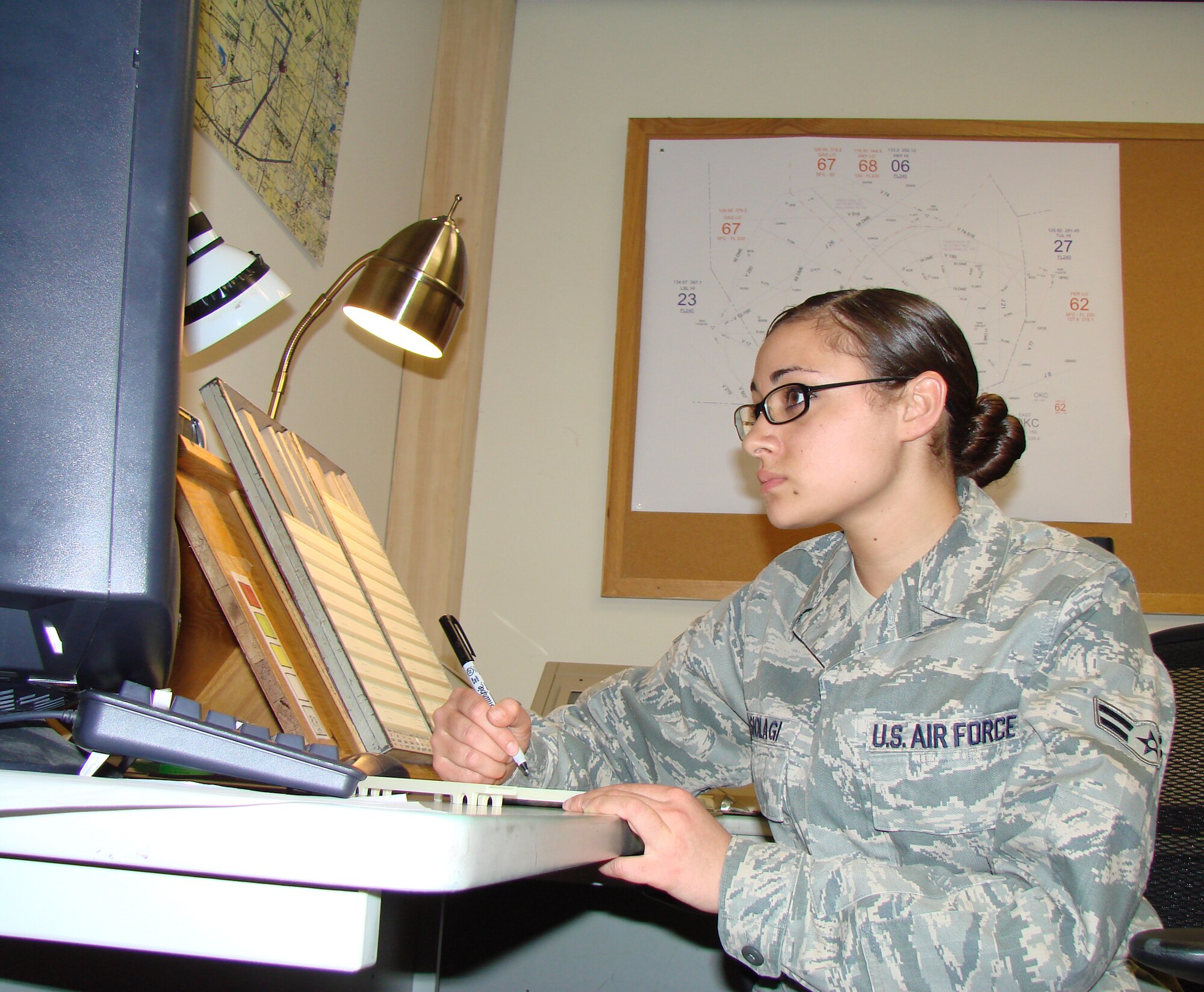 Airman 1st Class Nive Leasiolagi, March Warrior of the Month and three-level apprentice air traffic controller with the 71st Operations Support Squadron, sits in front of an air traffic simulator. 