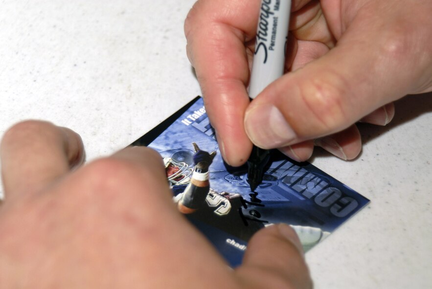 Chad Hennings, a former A-10 pilot and Dallas Cowboy signs cards for Airmen at the Pentagon March 27. Mr. Hennings is a motivational speaker and discussed the challenges of balancing career and family as well as his life experiences in the Air Force and the NFL. (U.S. Air Force photo/Staff Sgt. J.G. Buzanowski)