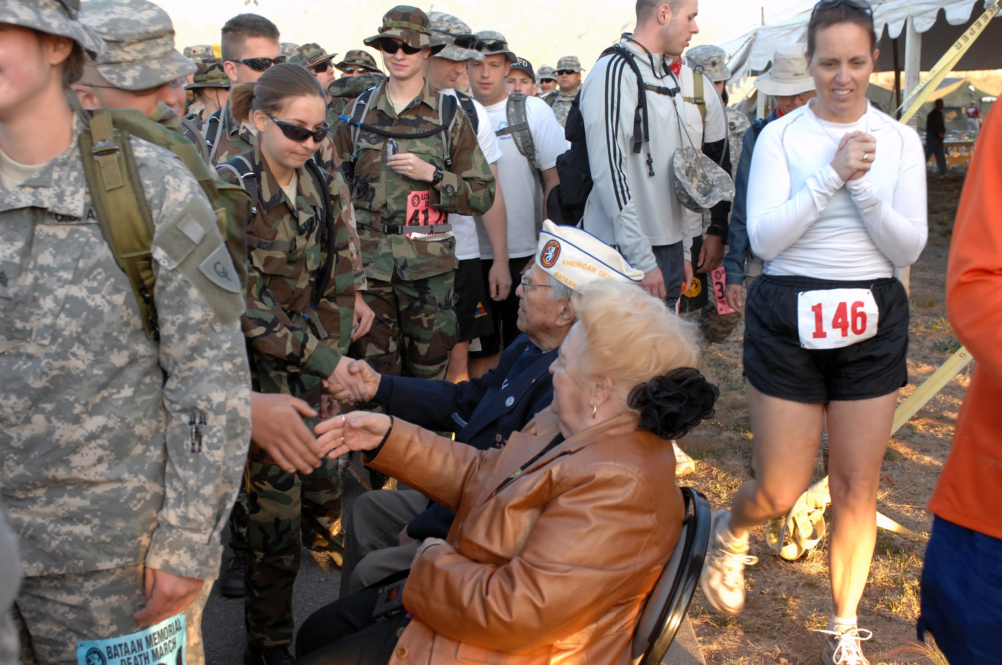 Bataan Death March survivor Carlos Montoya shakes hands with some of the more than 4,400 participants in the 19th Annual Bataan Memorial Death March March 30 at White Sands Missile Range, N.M. Military units from all 50 states as well as more than a dozen foreign countries gathered to honor the men who endured the death march in 1942 and prisoner of war hardships until 1945. (U.S. Air Force photo/Greg Allen) 
